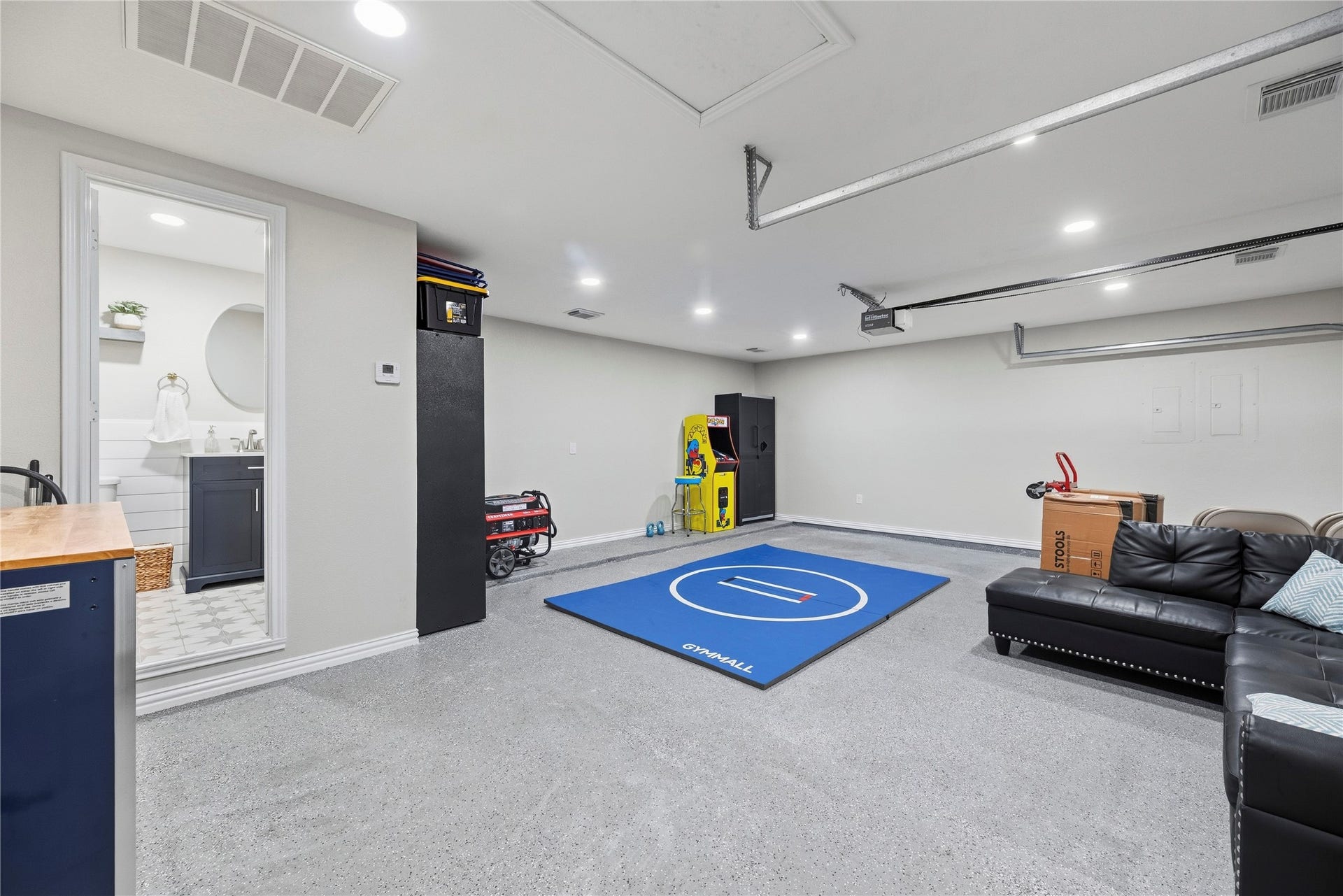 26819 Rockwood Park Lane, Cypress, TX 77433 Climate-controlled 2-car garage with A/C, durable epoxy flooring and a convenient half bathcurrently configured as a versatile recreation space while retaining full functionality as a garage.
