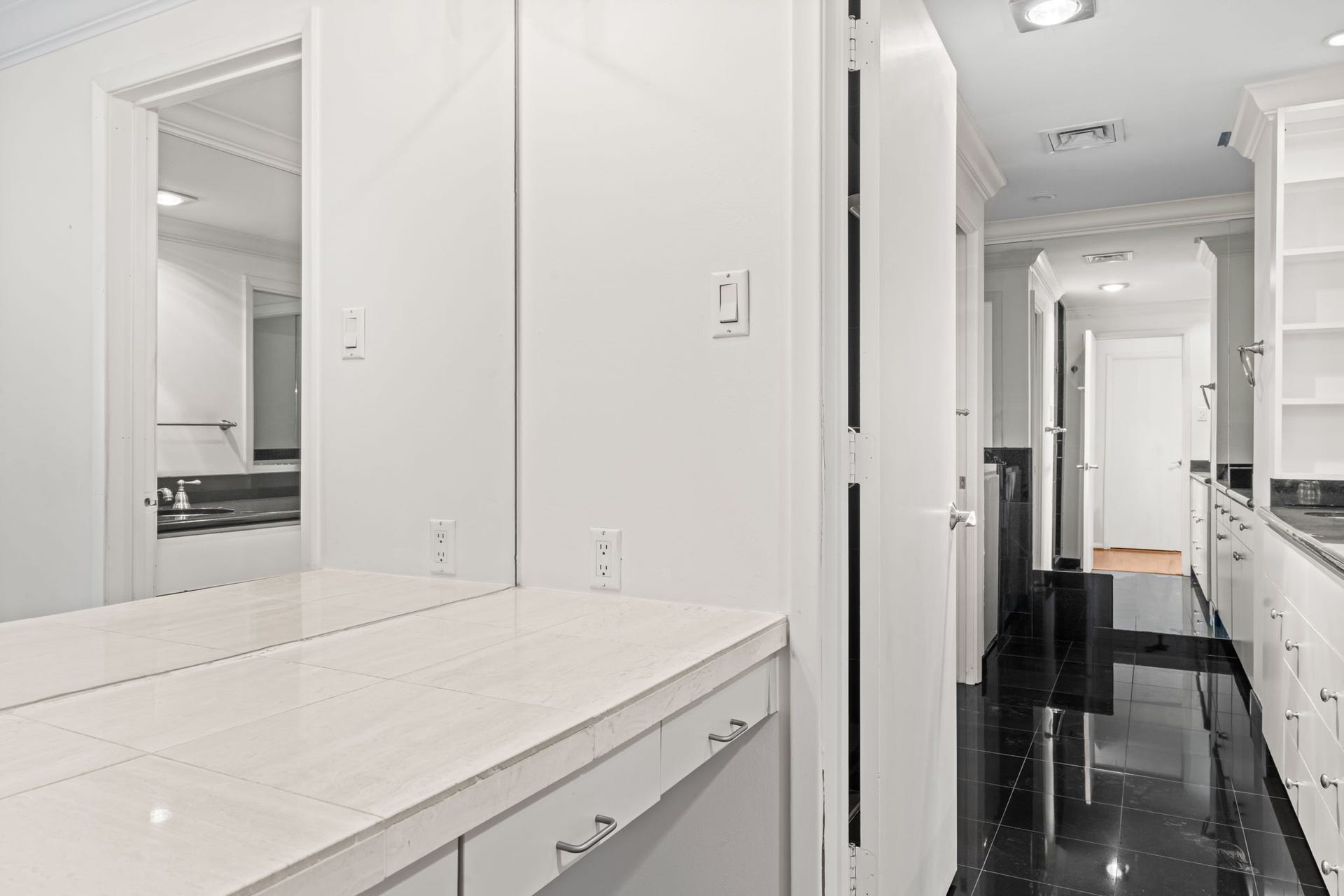The remodeled primary bathroom combines a streamlined vanity with refined finishes and abundant illumination. Its spacious design creates a calm and functional environment for daily routines.