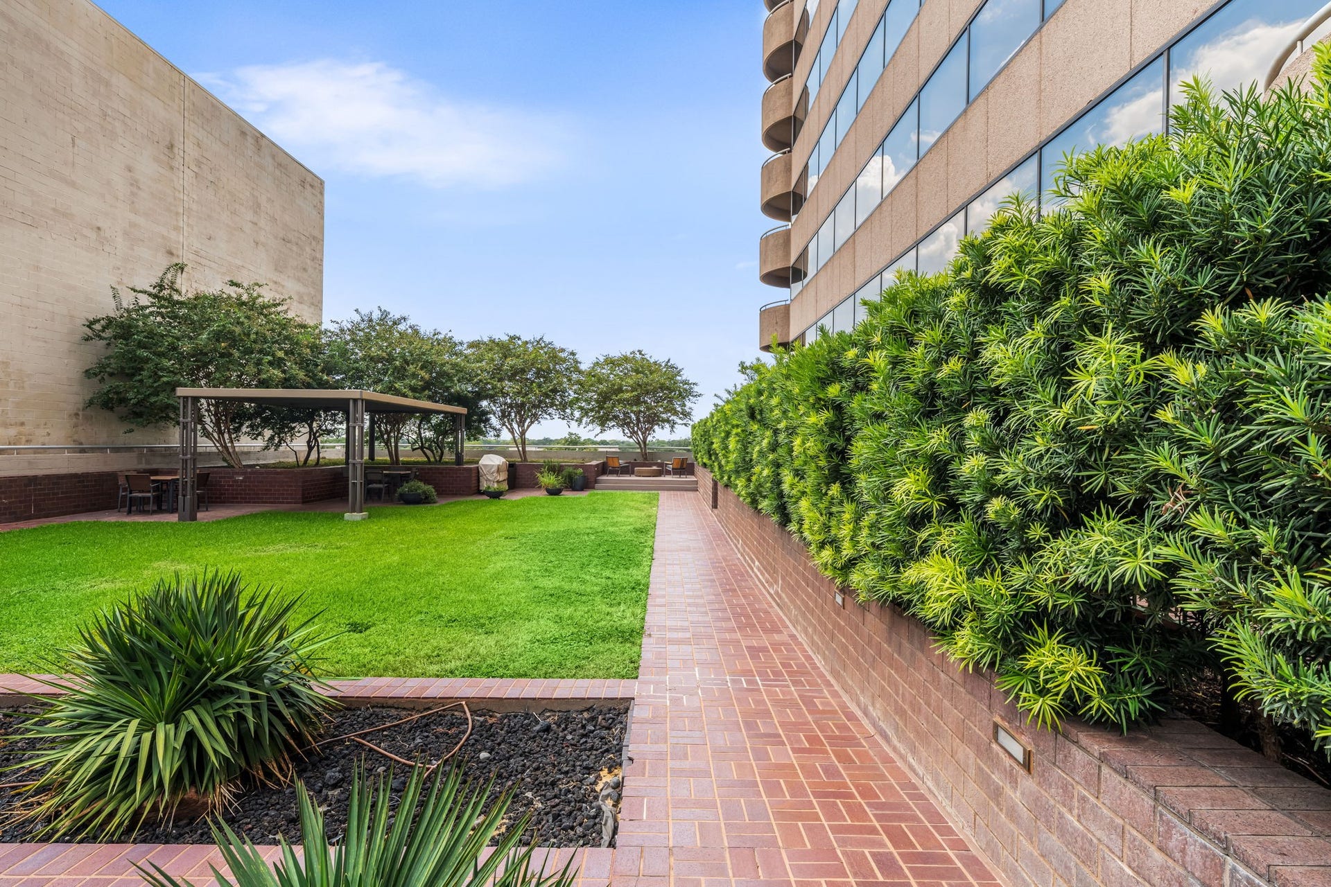 Landscaped sixth-floor grounds provide a welcoming outdoor escape within the building. Mature greenery and broad walkways create a tranquil setting for residents and their guests.