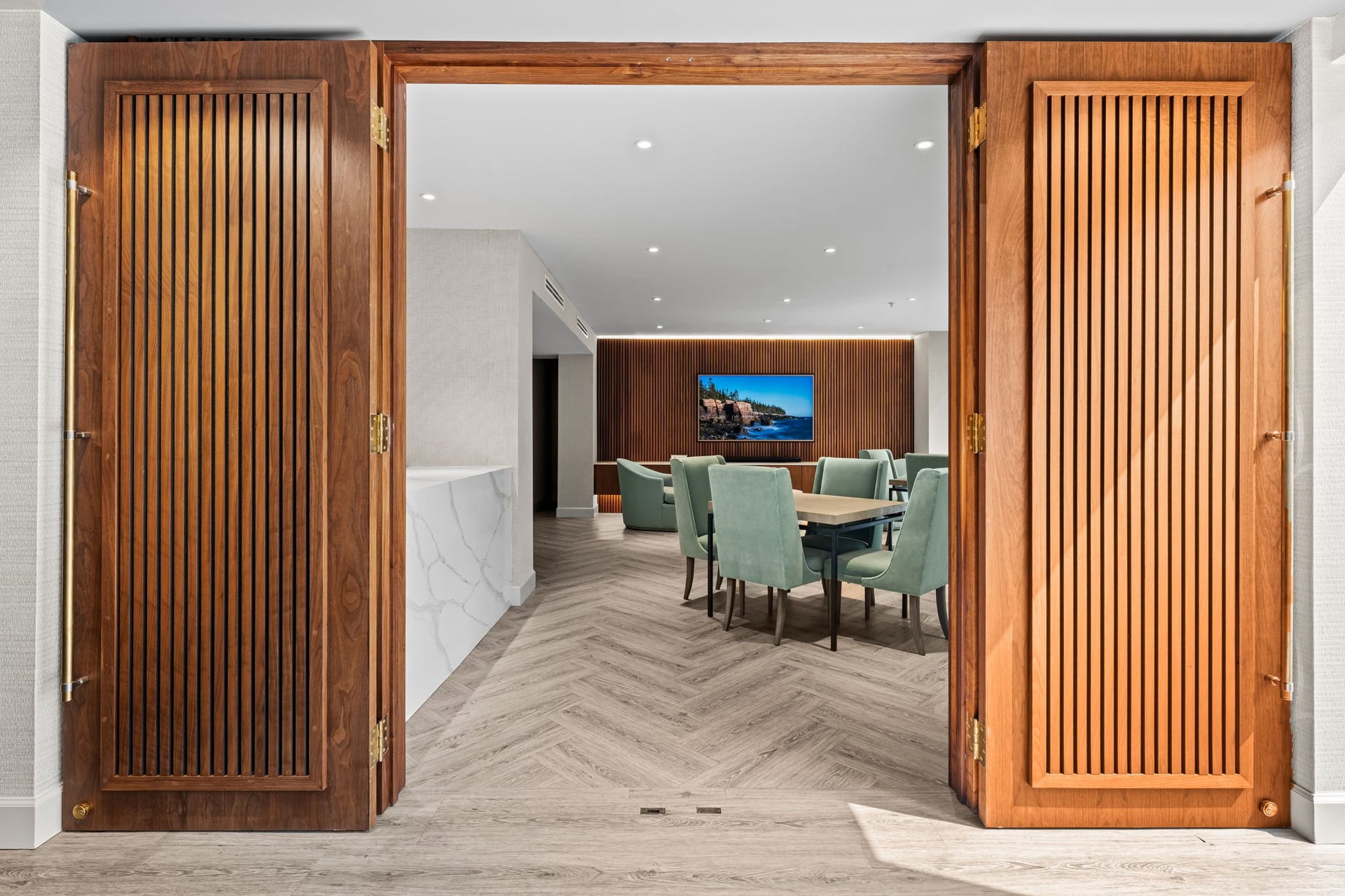 Recently renovated resident entertaining space opens directly toward the pool and landscaped outdoor area. This seamless connection makes the sixth floor well suited to gatherings and community events.