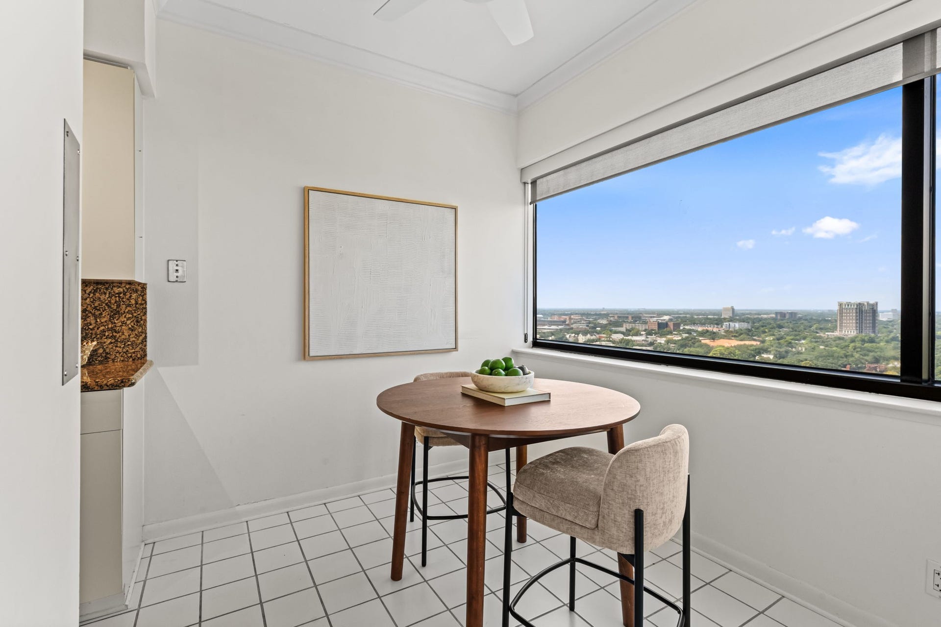 A bright breakfast area offers a more casual setting beside a large picture window. Natural light and neighborhood views make this an inviting place to begin the day.