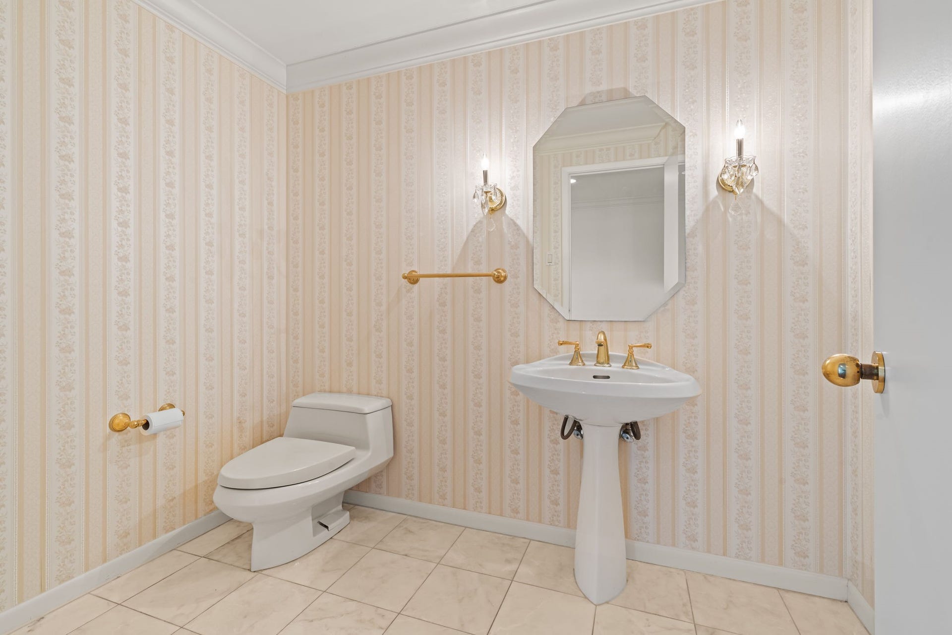 The powder room presents a polished, neutral design with refined finishes and a thoughtfully arranged vanity. Its elegant presentation provides a welcoming convenience for guests.