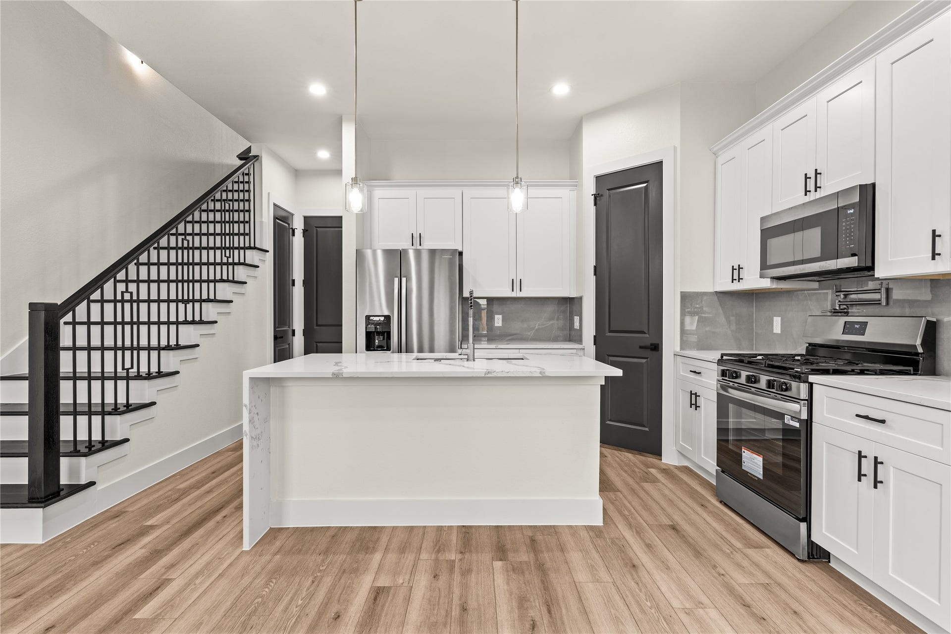 4521 Newberry Street, Houston, TX 77051 Gourmet kitchen and dining hub glass drop pendant lighting, stainless steel appliance package, and step-in pantry storage.