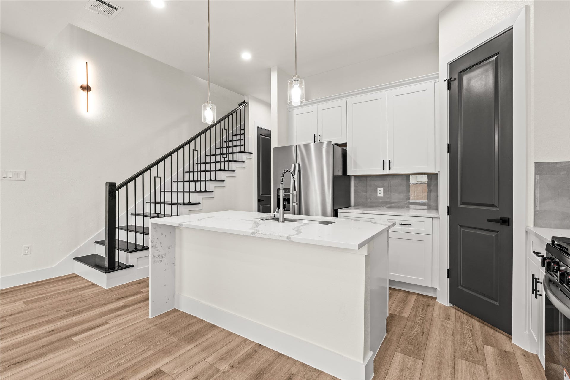 4521 Newberry Street, Houston, TX 77051 Thoughtfully crafted prep area undermount sink inset into the waterfall quartz counter, matte black hardware, and crisp contrast finishes.