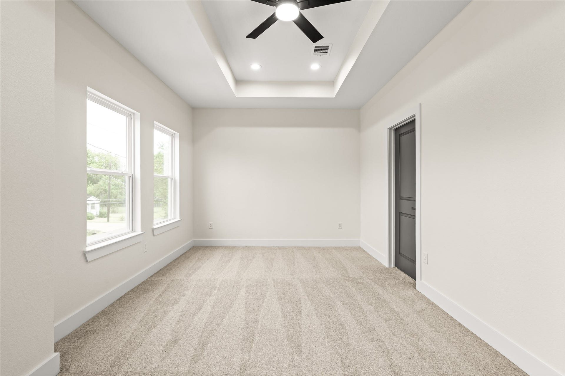 4521 Newberry Street, Houston, TX 77051 Primary suite sanctuary oversized dual windows streaming natural light, high tray ceiling, and direct private access to the ensuite bath.