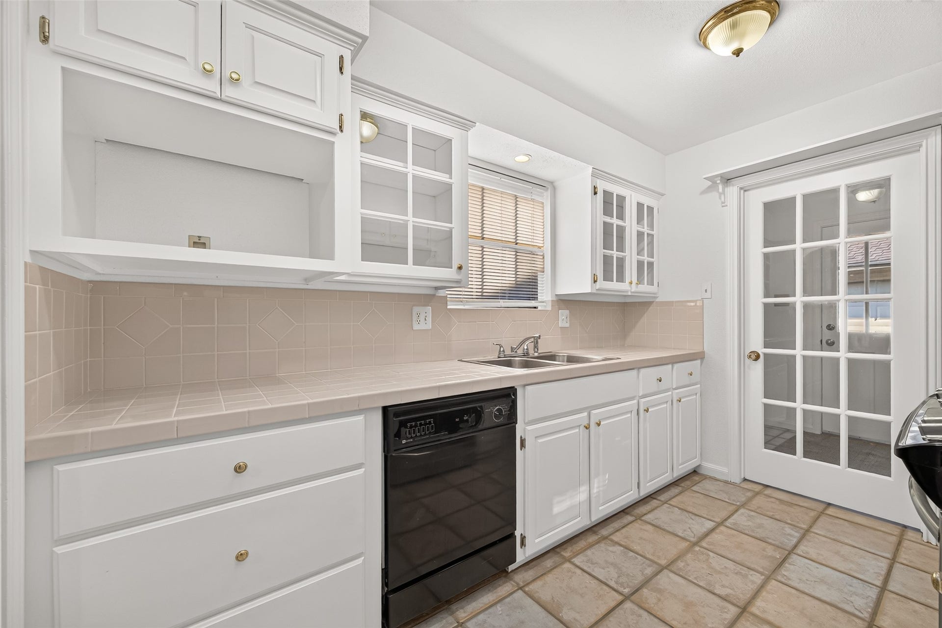 7602 Salge Drive, Houston, TX 77040 Functional kitchen featuring white custom cabinetry and generous counter space.