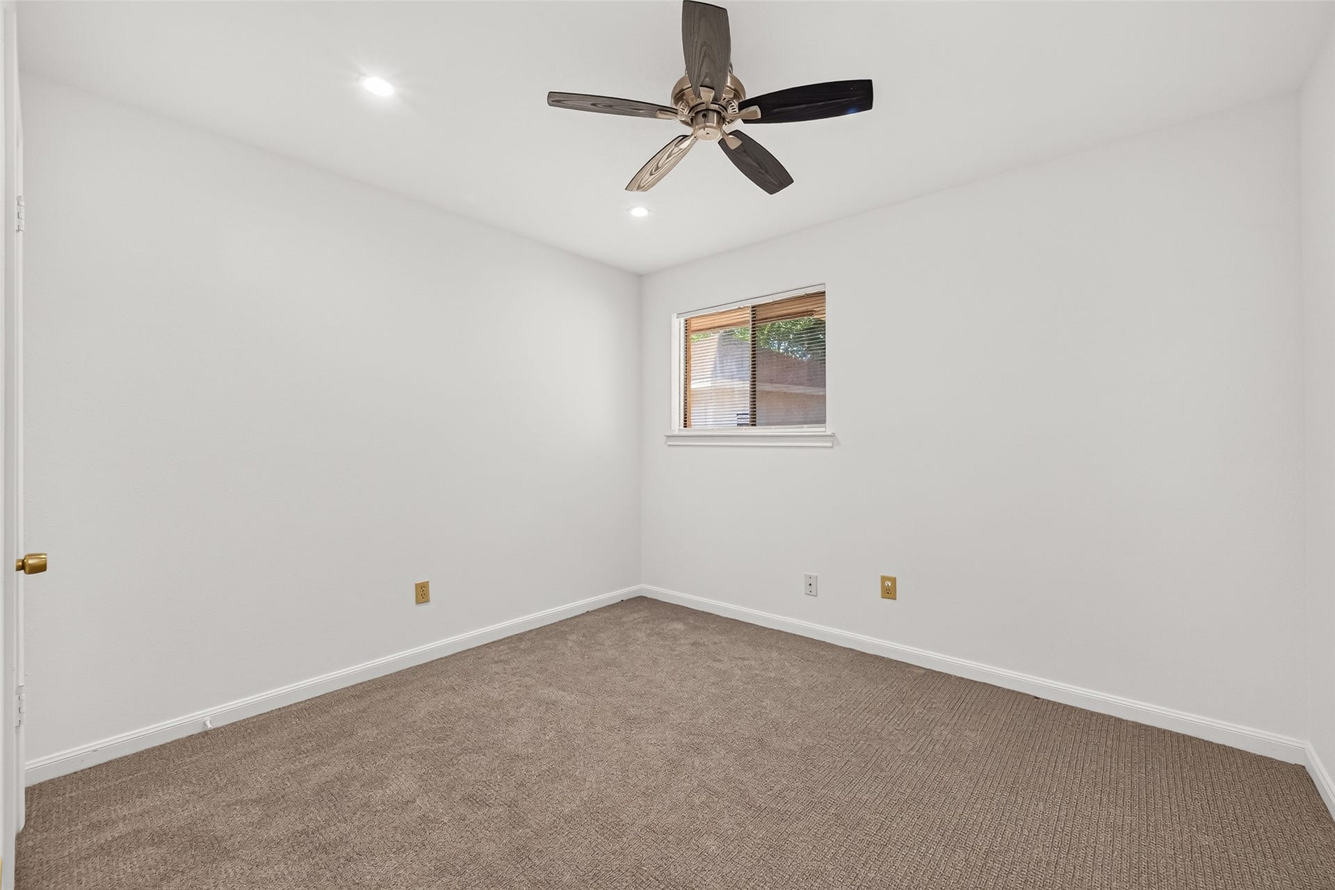 7602 Salge Drive, Houston, TX 77040 Freshly painted secondary bedroom featuring neutral carpeting, recessed lighting, and a modern ceiling fan creating a bright and comfortable space.