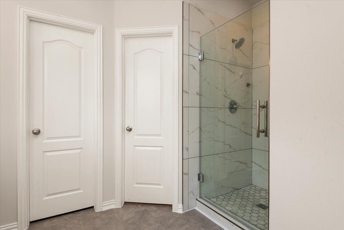 16123 Laura Beth Drive, Hockley, TX 77447 Primary bathroom w/updated shower. The door on the left is the private toilet room and the door on the right is the 2nd walk-in closet.