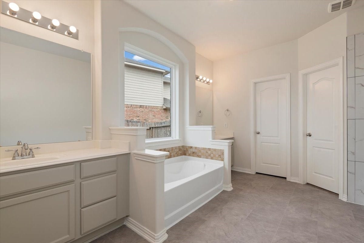 16123 Laura Beth Drive, Hockley, TX 77447 Primary en-suite with dual vanities, soaking tub, and separate shower. Fresh paint & updated shower.