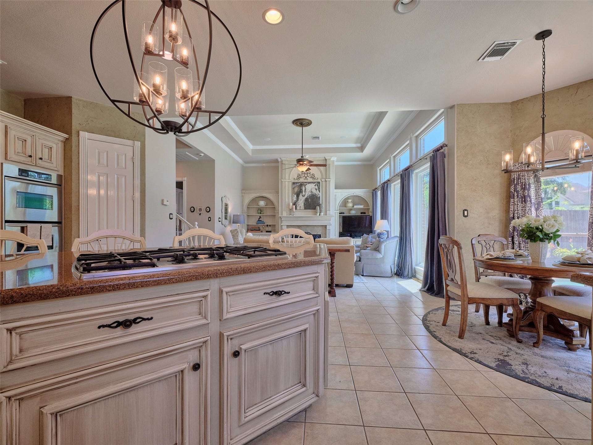 7111 Mohave Hills, Houston, TX 77069 Spacious open-concept living area featuring a gourmet kitchen with elegant cabinetry and modern appliances, flowing into a cozy family room with abundant natural light and a stylish dining nook.