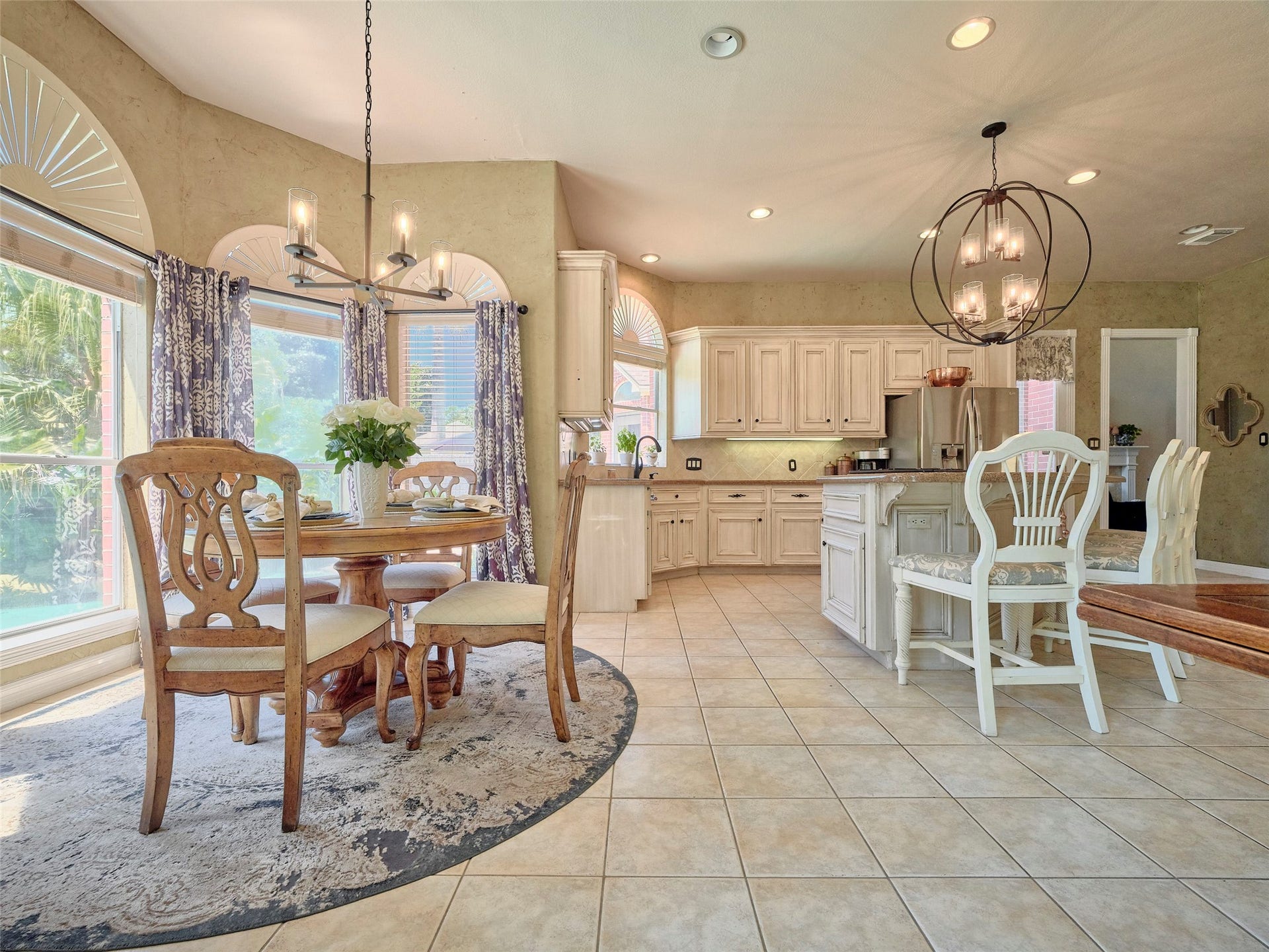 7111 Mohave Hills, Houston, TX 77069 Bright and inviting kitchen with elegant cabinetry, a spacious island, and a cozy breakfast nook bathed in natural light from large windows.