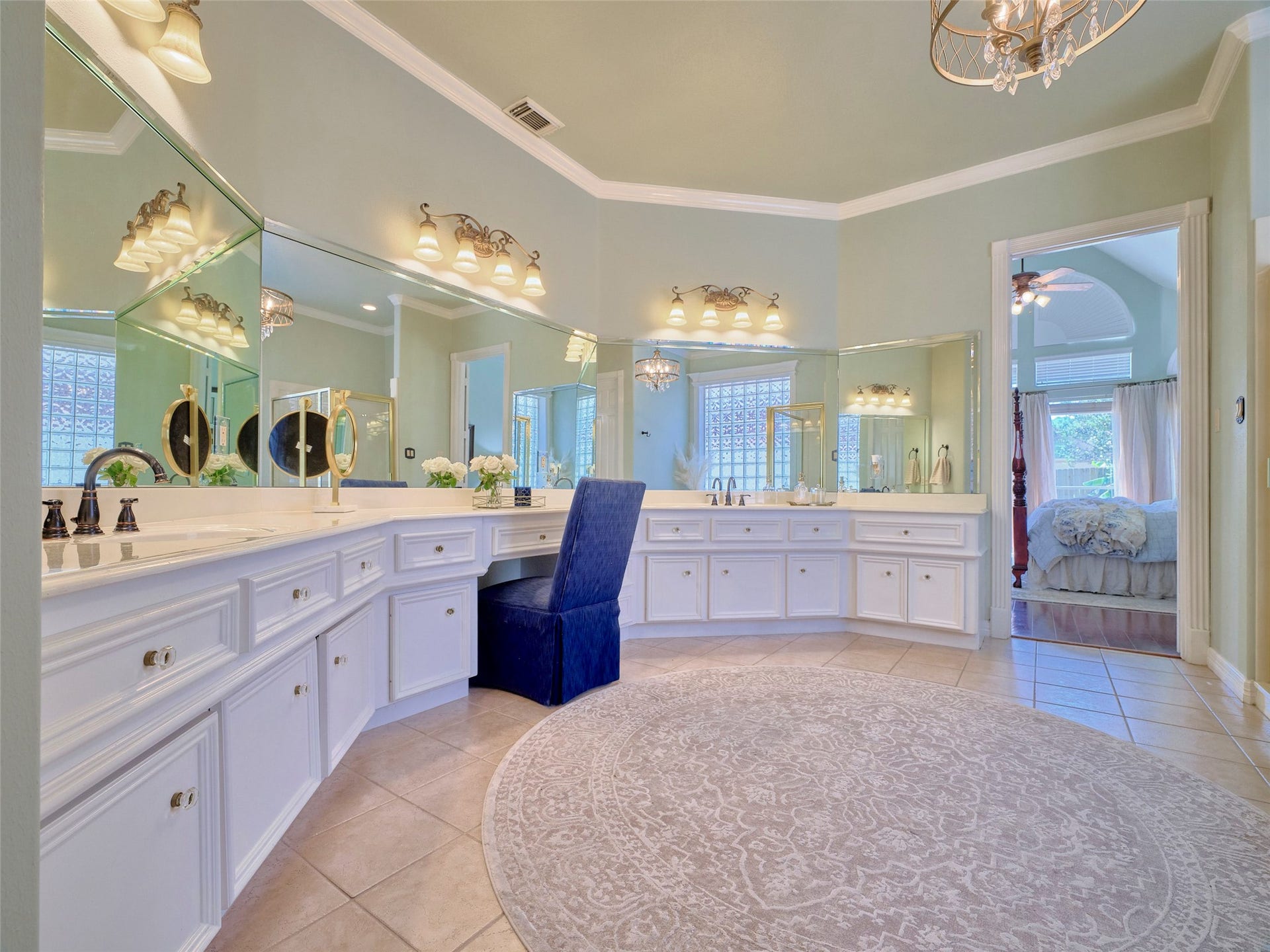 7111 Mohave Hills, Houston, TX 77069 Luxurious primary bathroom featuring dual vanities with ample storage, elegant lighting, and a plush seating area, seamlessly connected to a spacious bedroom.