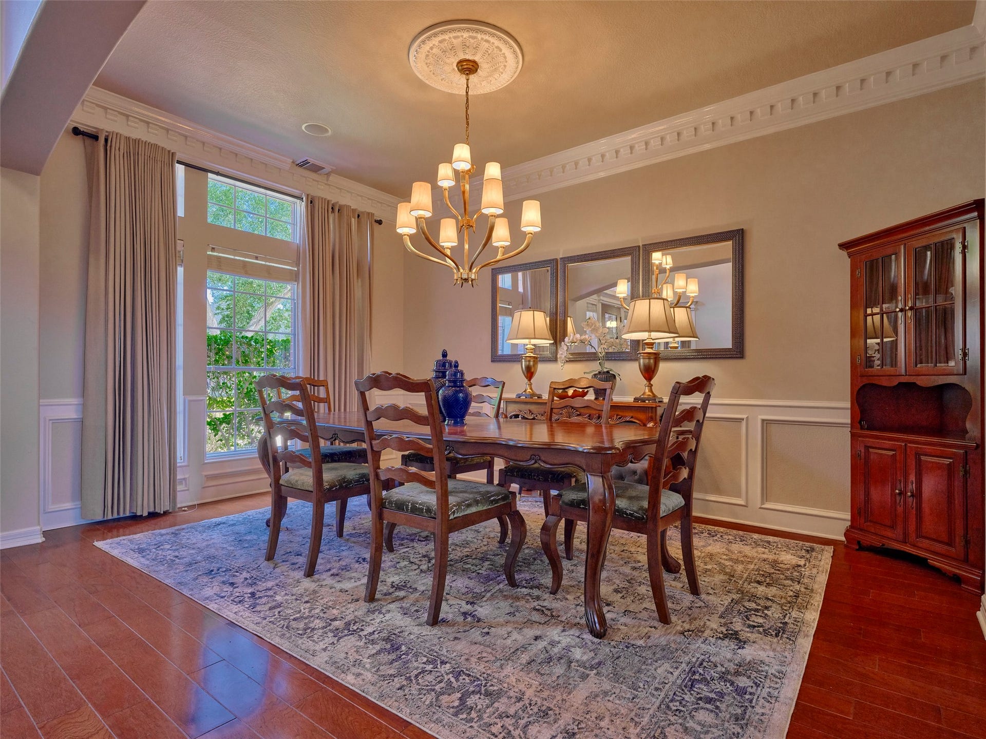 7111 Mohave Hills, Houston, TX 77069 Elegant dining room featuring a classic chandelier, rich wood furnishings, and a large window with natural light.