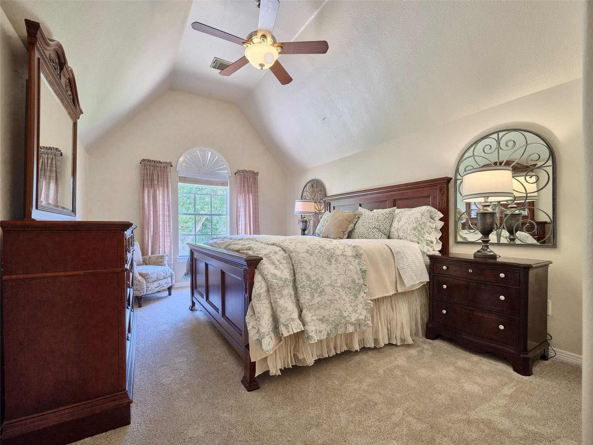 7111 Mohave Hills, Houston, TX 77069 Spacious bedroom featuring vaulted ceilings, elegant furniture, and a large window with soft drapes that invites natural light.