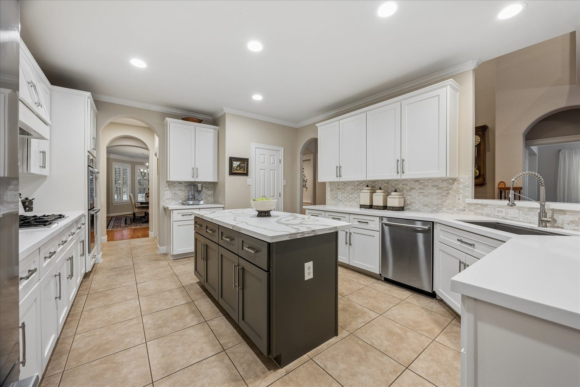 Features gas cooktop, double ovens, and ample counter and storage space.
