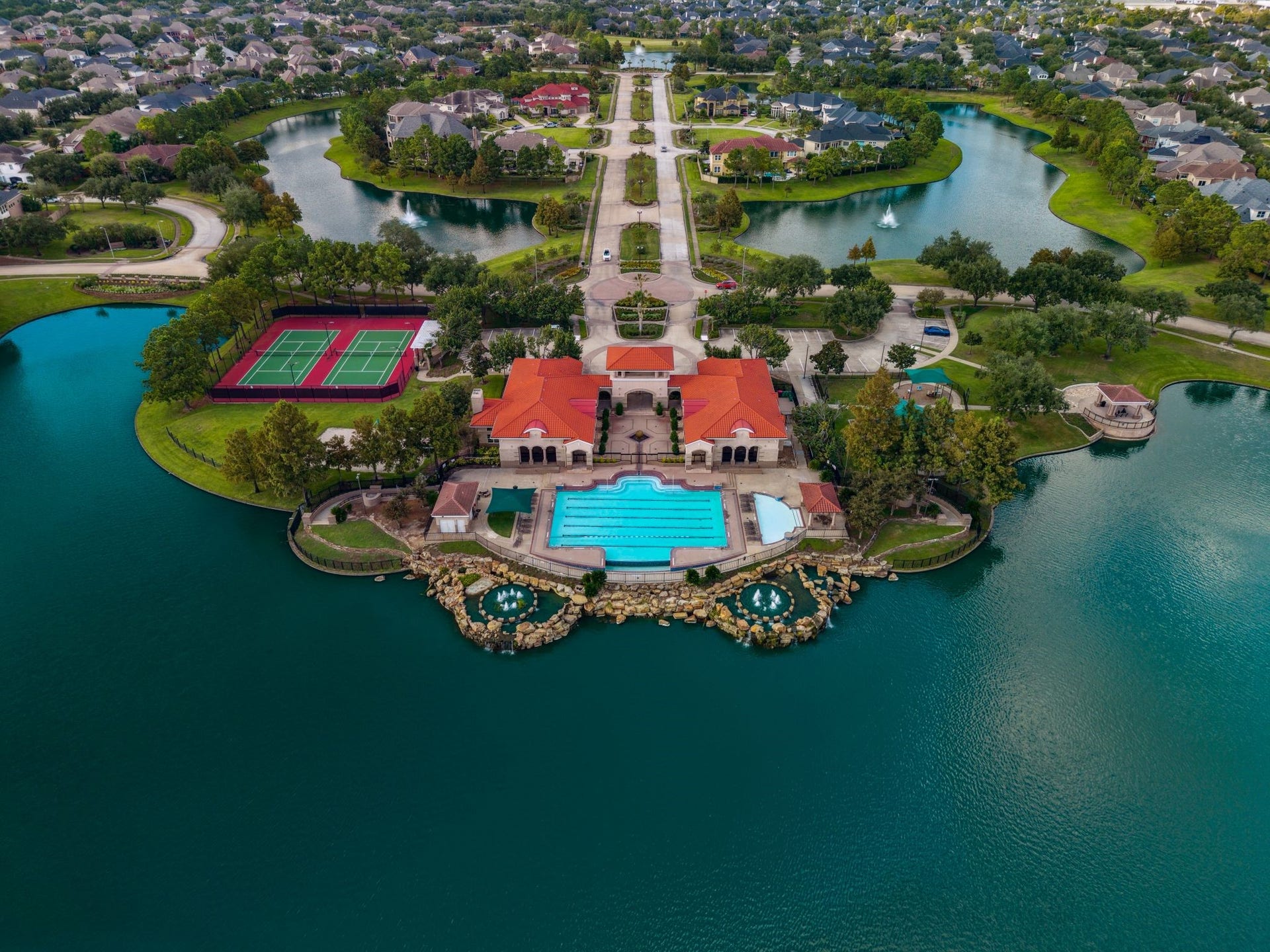 Experience a premier resort-style lifestyle in a secure, manned-gate community boasting a clubhouse, fitness center, lighted tennis and pickleball courts, sand volleyball, dual pools, and miles of scenic trails and playgrounds.