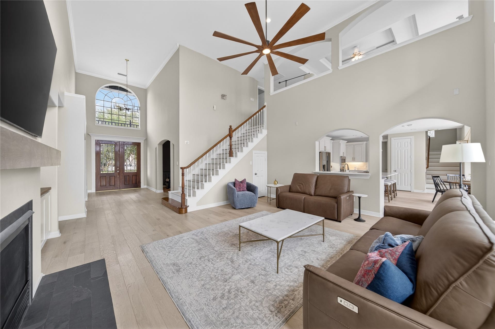 8826 Crown Jewel Drive, Richmond, TX 77469 Step into elegance with this spacious living area, where new white oak wood floors seamlessly flow throughout, enhancing the home's modern sophistication.