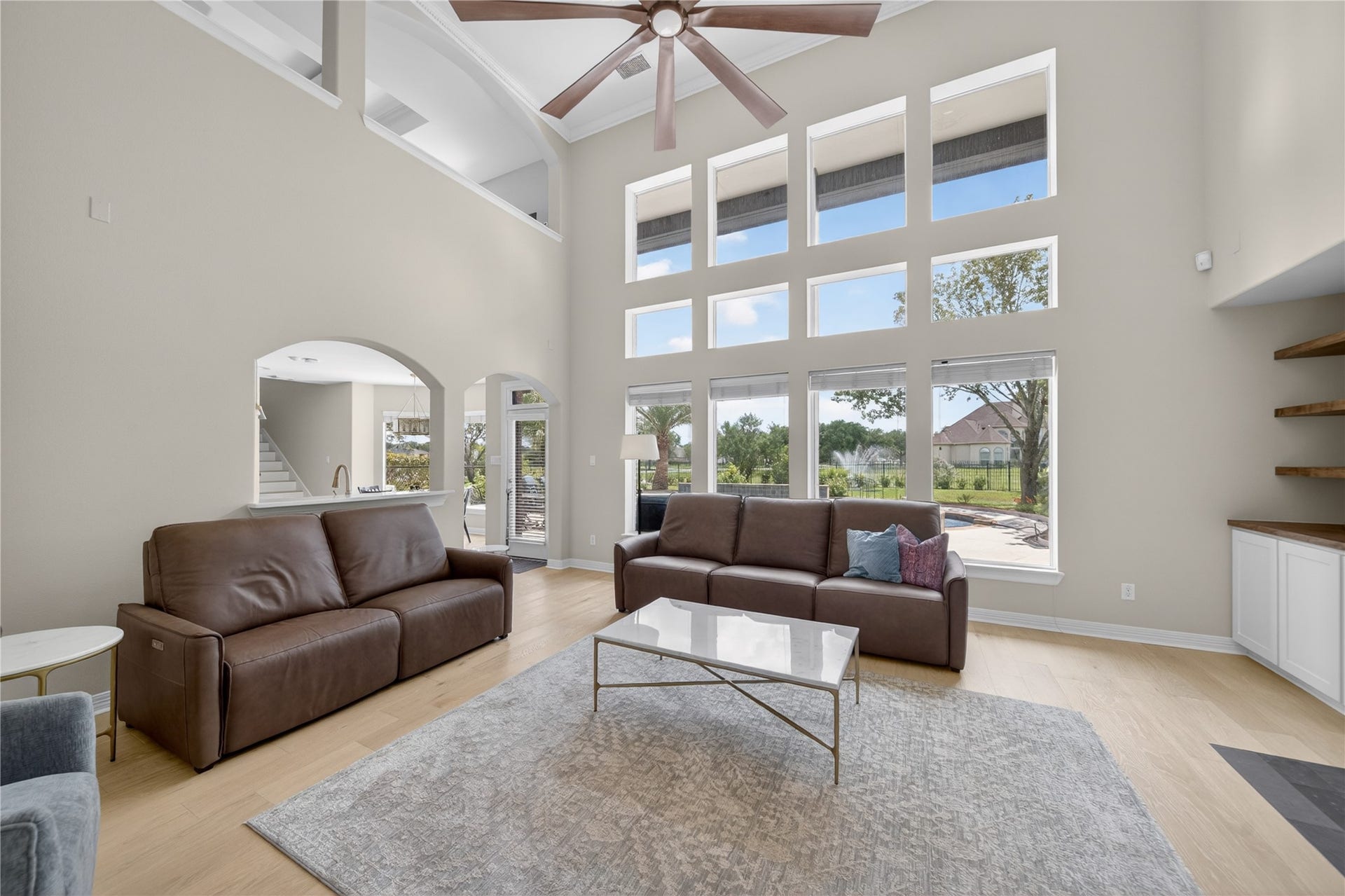 8826 Crown Jewel Drive, Richmond, TX 77469 Experience breathtaking views through a stunning wall of windows, overlooking your private pool, hot tub, and serene lake.