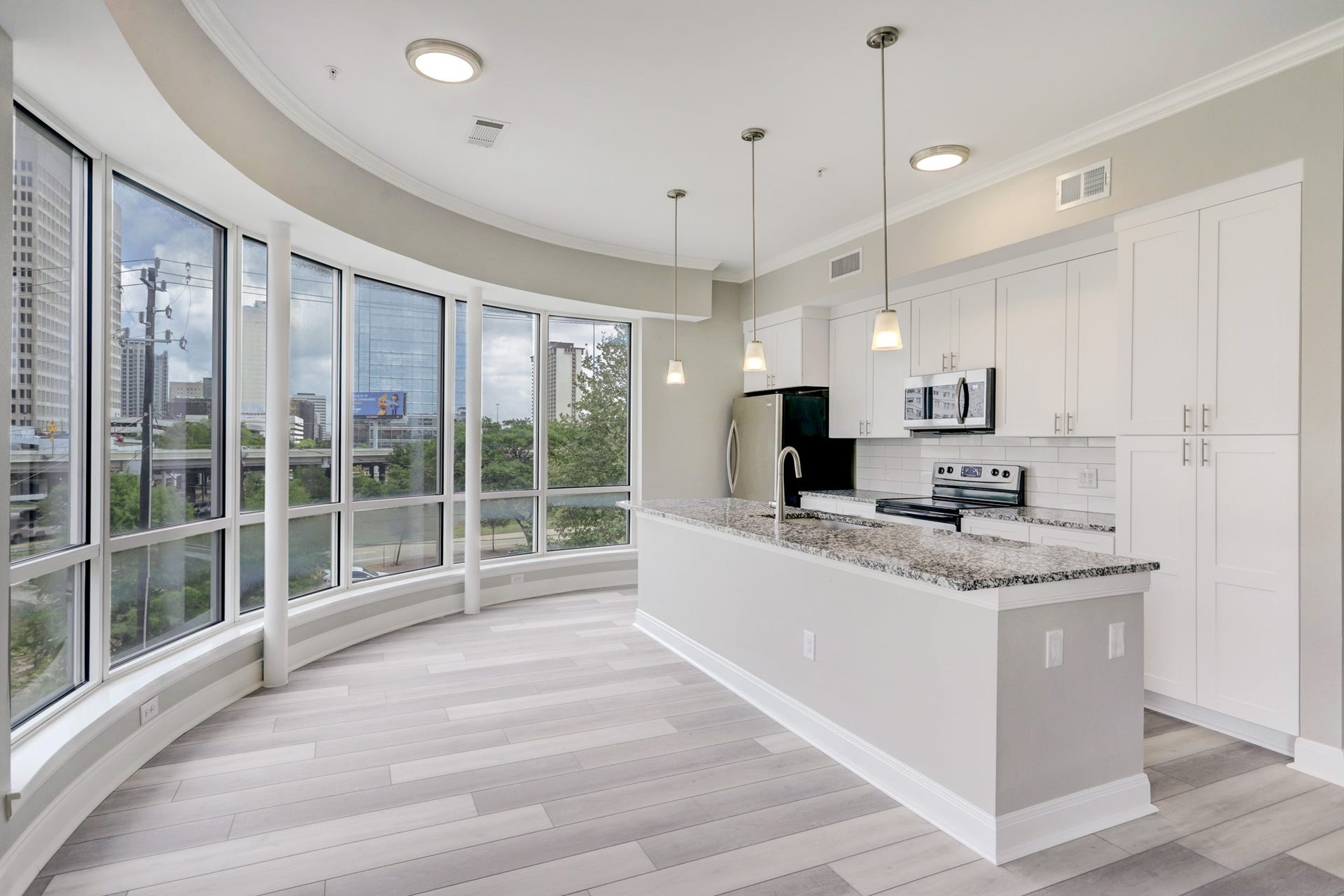 300 St Joseph Parkway, #212, Houston, TX 77002 The Dining area enjoys these amazing curved windows with views onto Downtown.