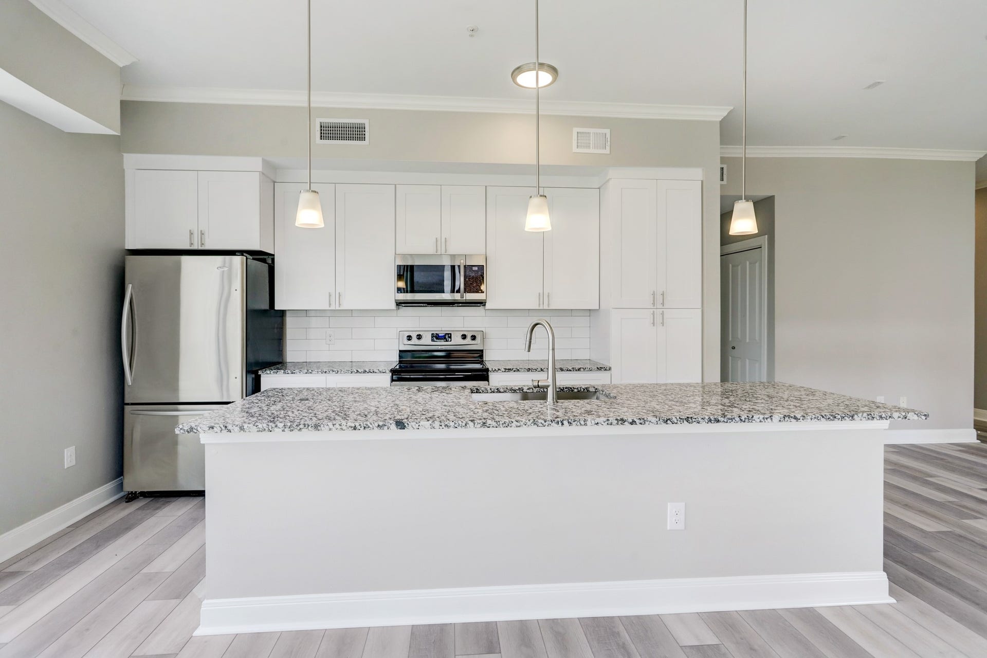 300 St Joseph Parkway, #212, Houston, TX 77002 Island Kitchen with pendant lighting accents.