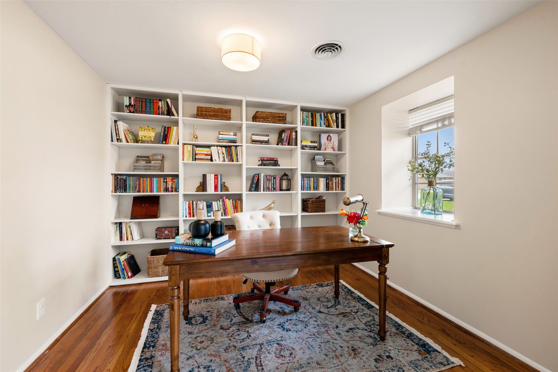 1343 Del Norte Street, Houston, TX 77018 Versatile study or home office featuring hardwood floors, natural light and a full wall of built-in bookshelves for ample storage and display.