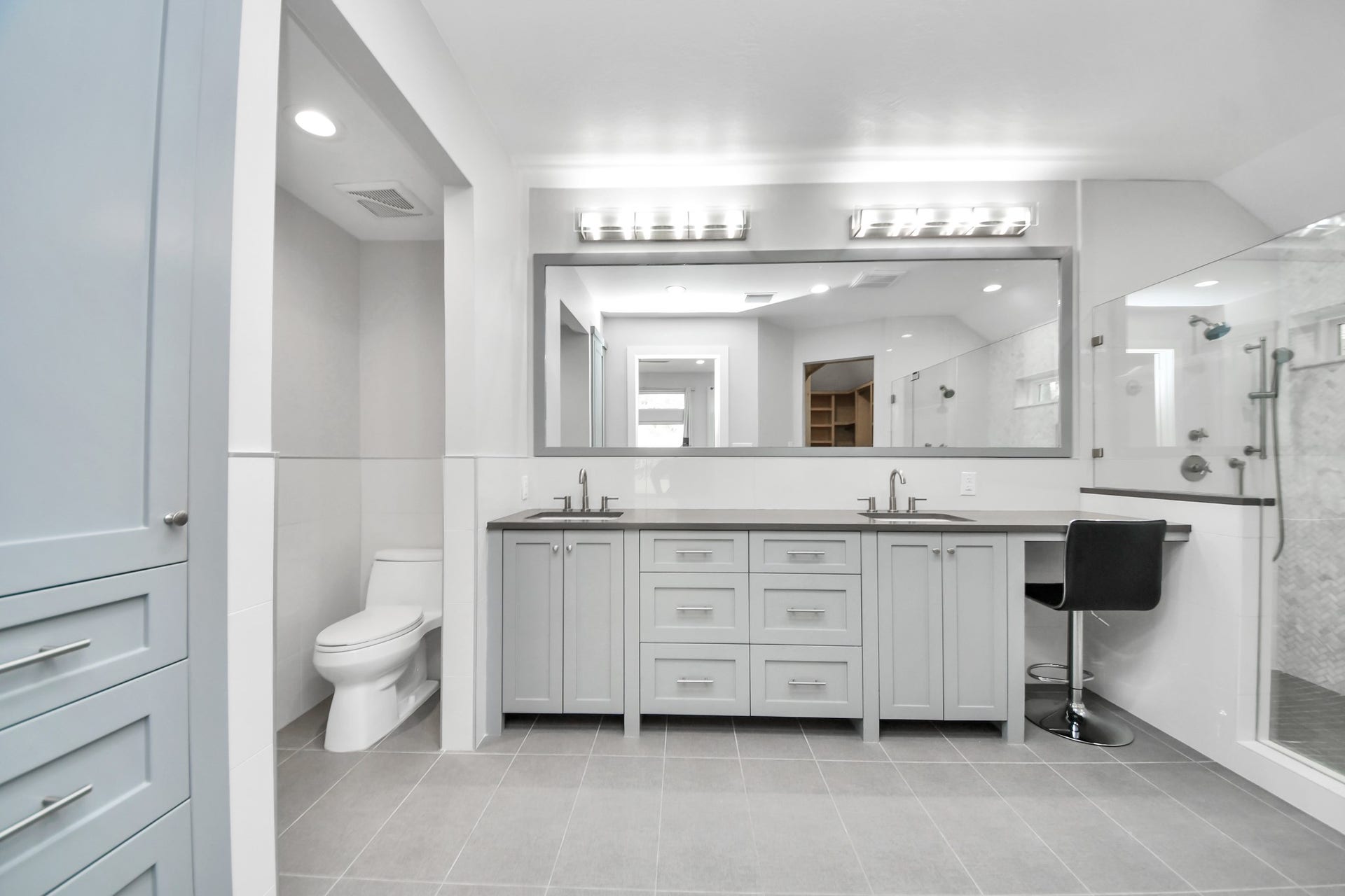 Primary bathroom with quartz countertops, all soft close solid wood custom cabinetry