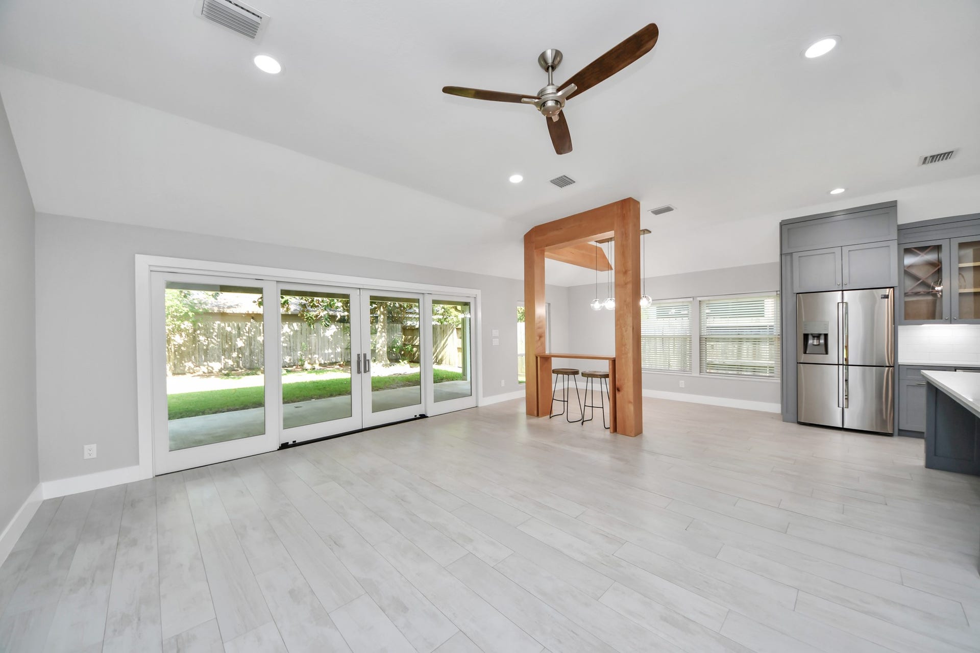 Spacious living room/great room showcasing a gorgeous sliding door and seamless ceramic tile flooring