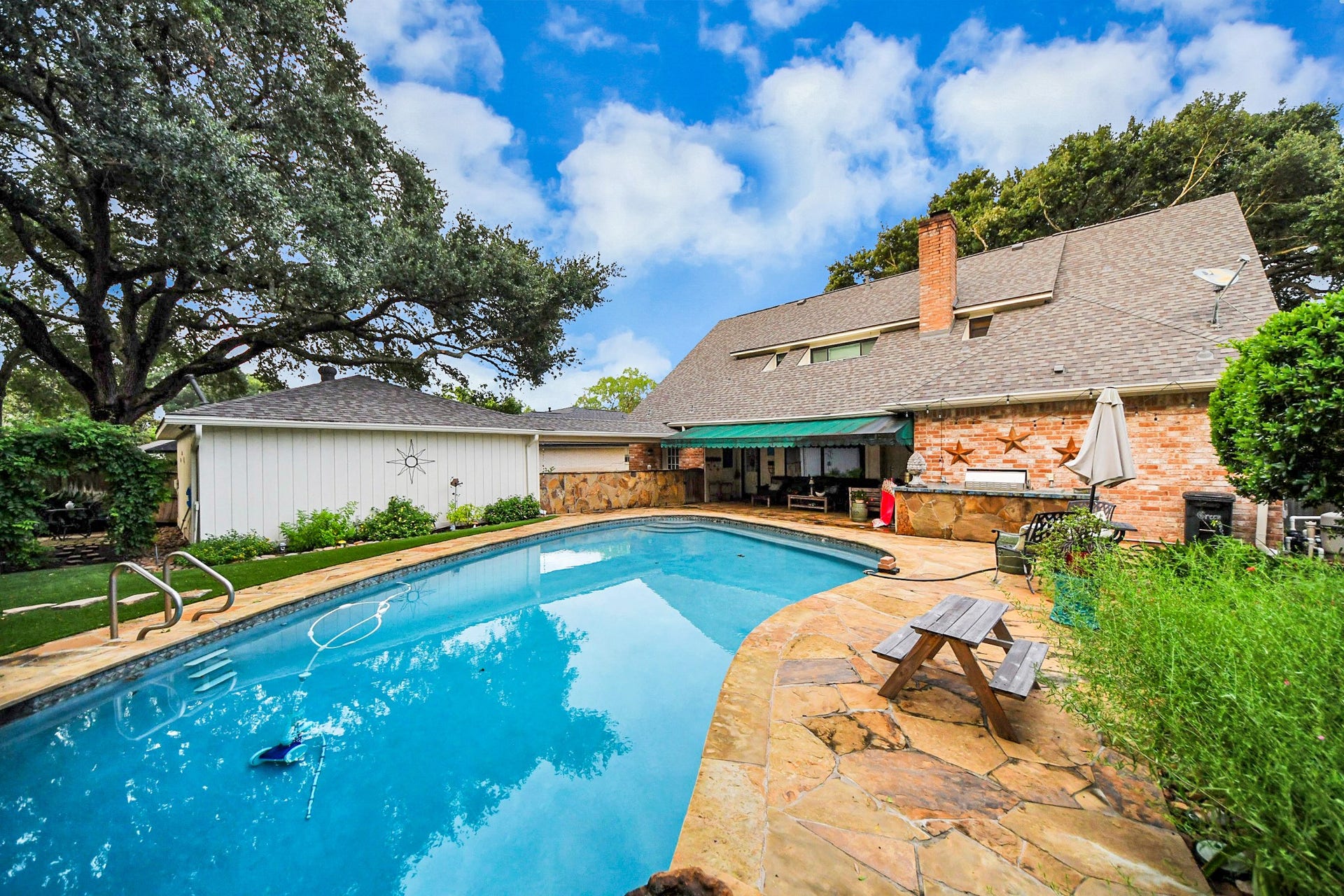 722 Chevy Chase Circle, Sugar Land, TX 77478 An expansive pool deck, covered patio and outdoor kitchen create plenty of space for entertaining.