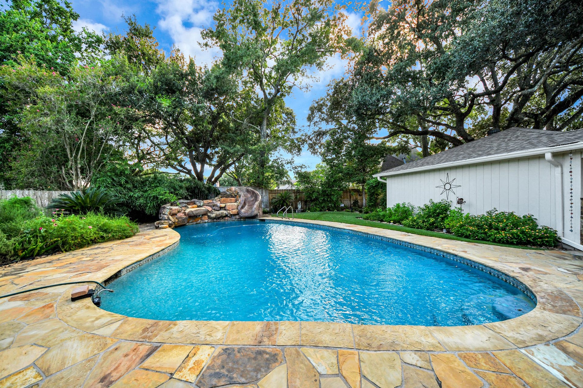 722 Chevy Chase Circle, Sugar Land, TX 77478 The backyard is the showstopper, with a large resort-style pool surrounded by mature trees and lush landscaping.