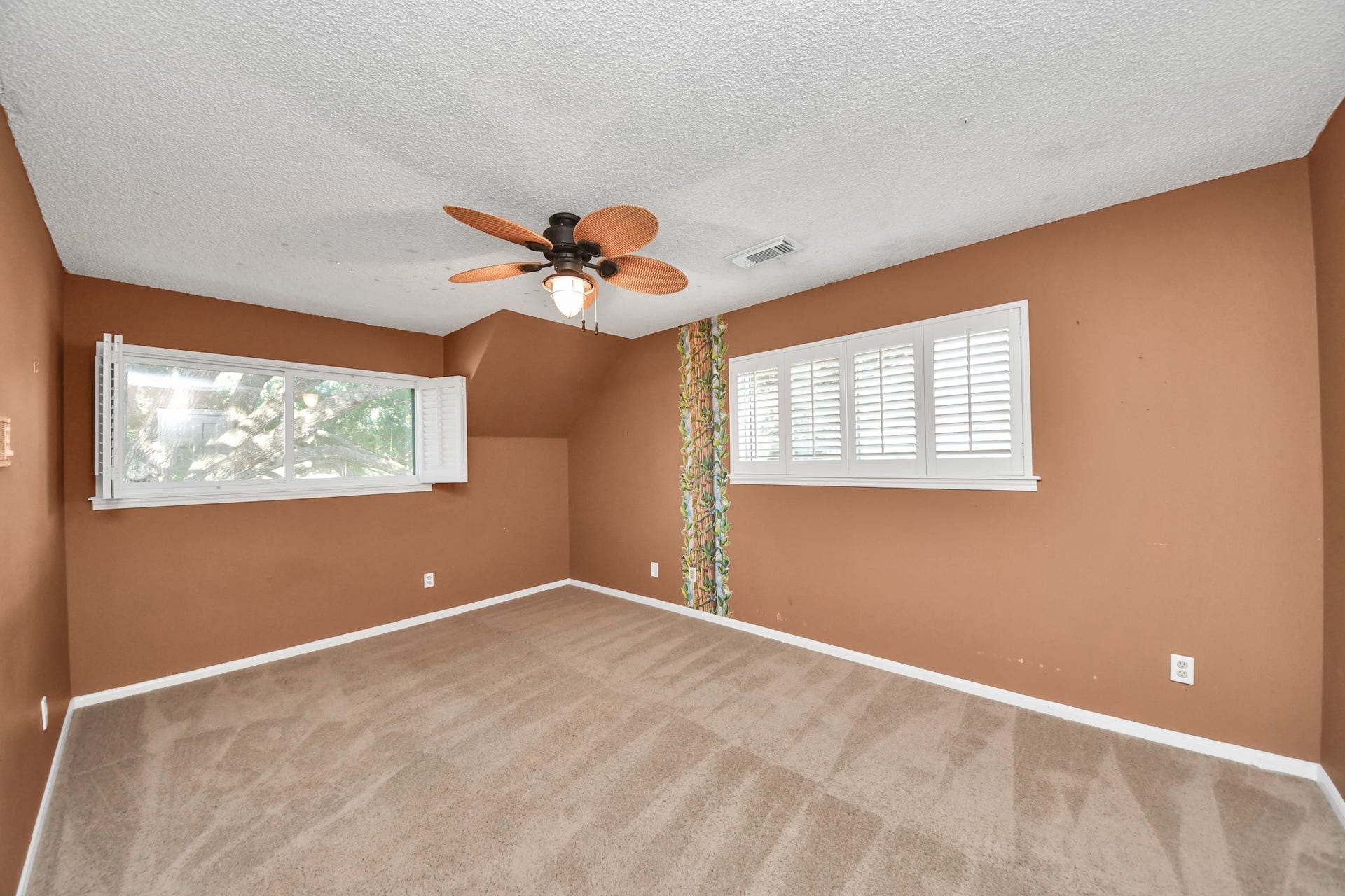 722 Chevy Chase Circle, Sugar Land, TX 77478 Multiple windows and plantation shutters bring natural light into this generously sized secondary bedroom.