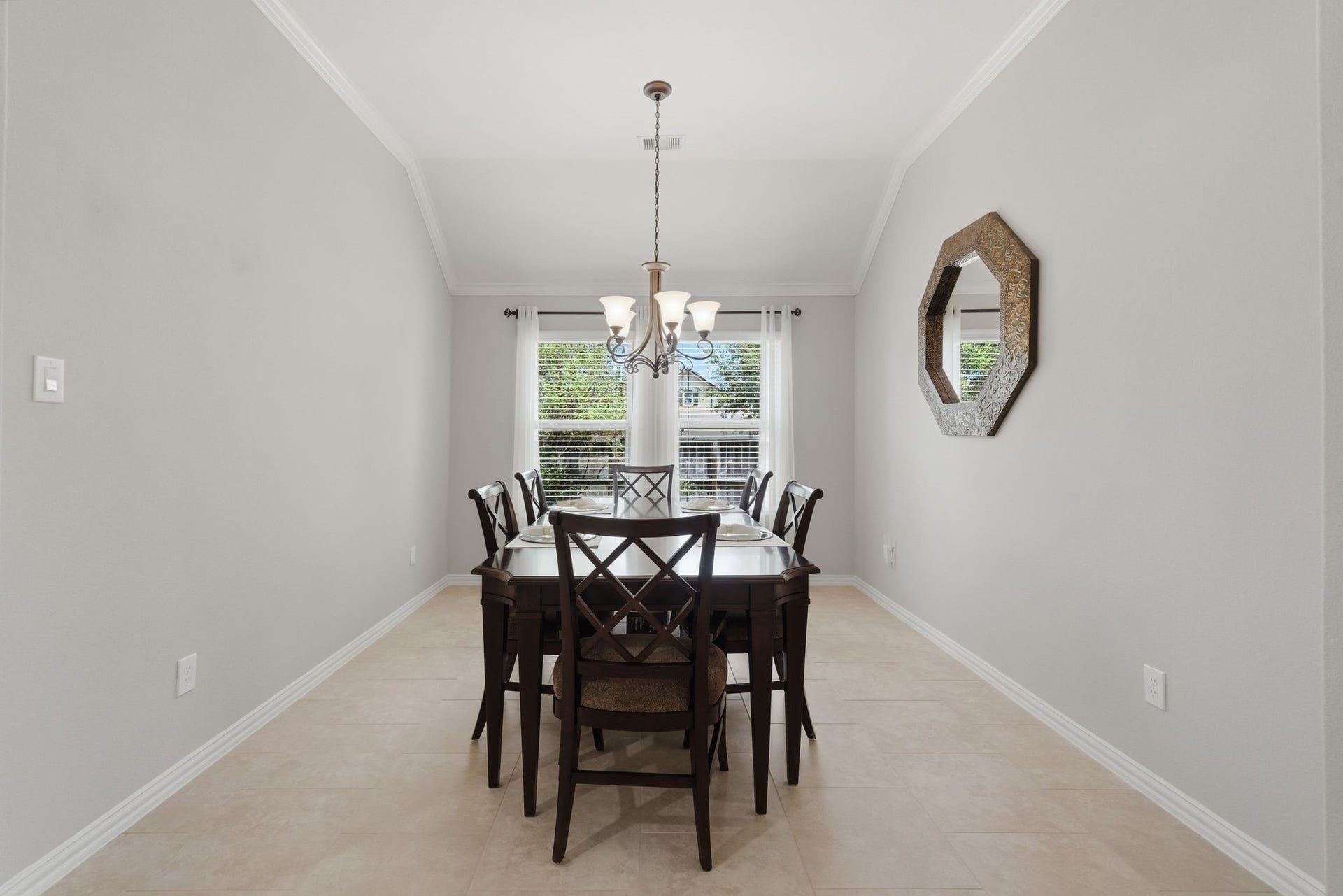 The view from the Formal Dining window is a bit elevated and overlooks the corner. With crown moulding and wrought iron light fixture, it makes a perfect backdrop to your gatherings.