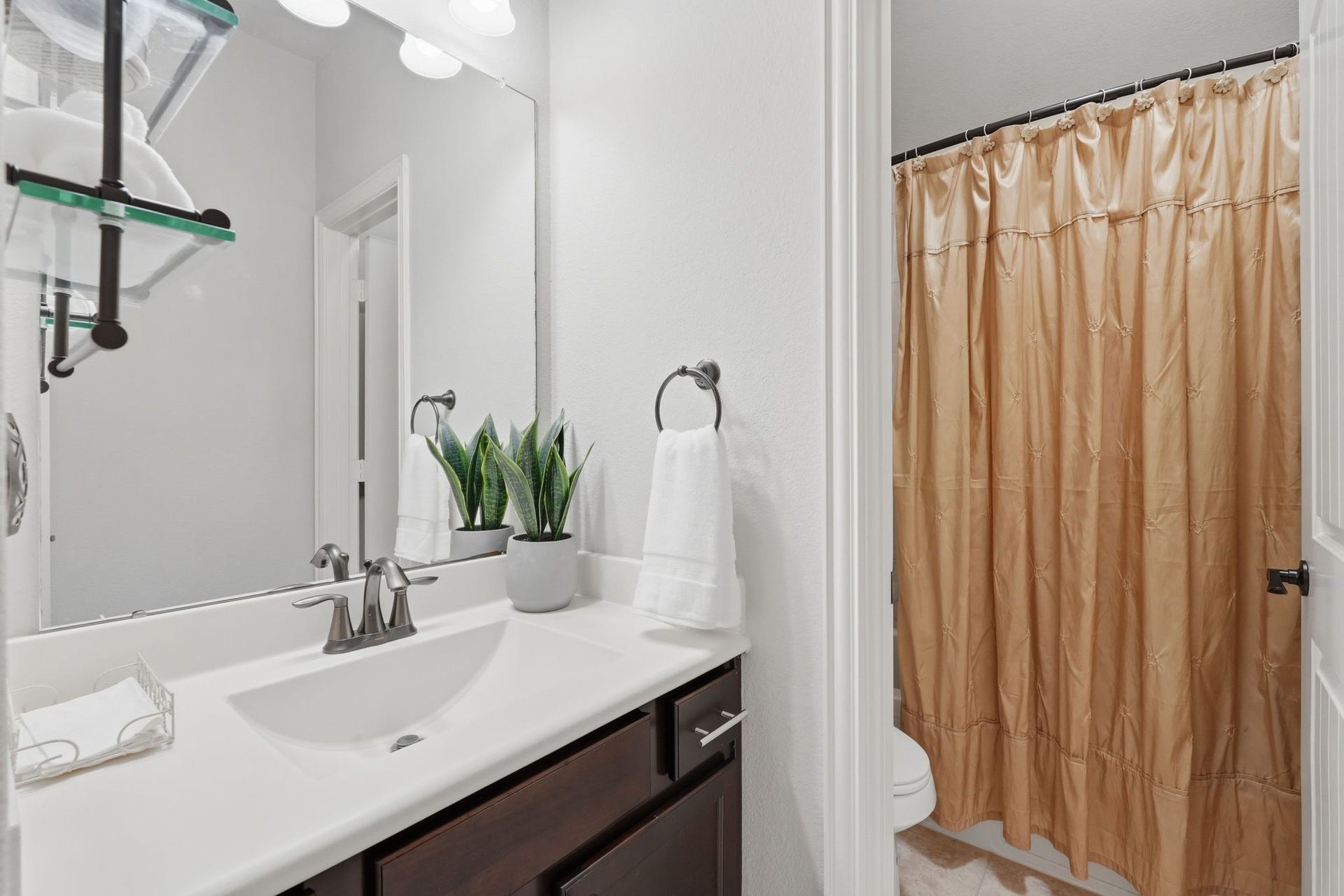 The secondary full bath has a separate sink area from the toilet and bath.