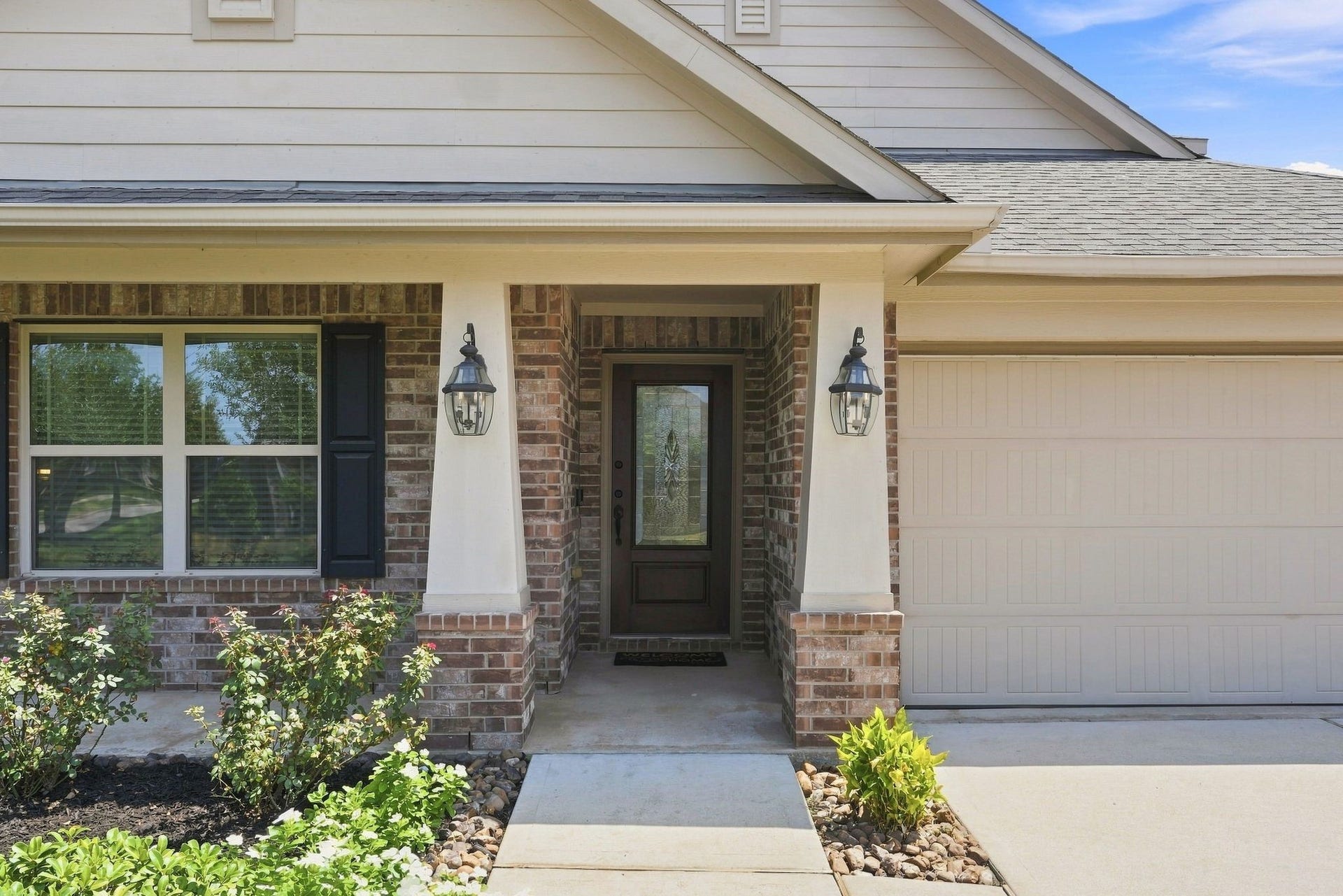 Enjoy fresh landscaping as you walk up to the charming Craftsman elevation.