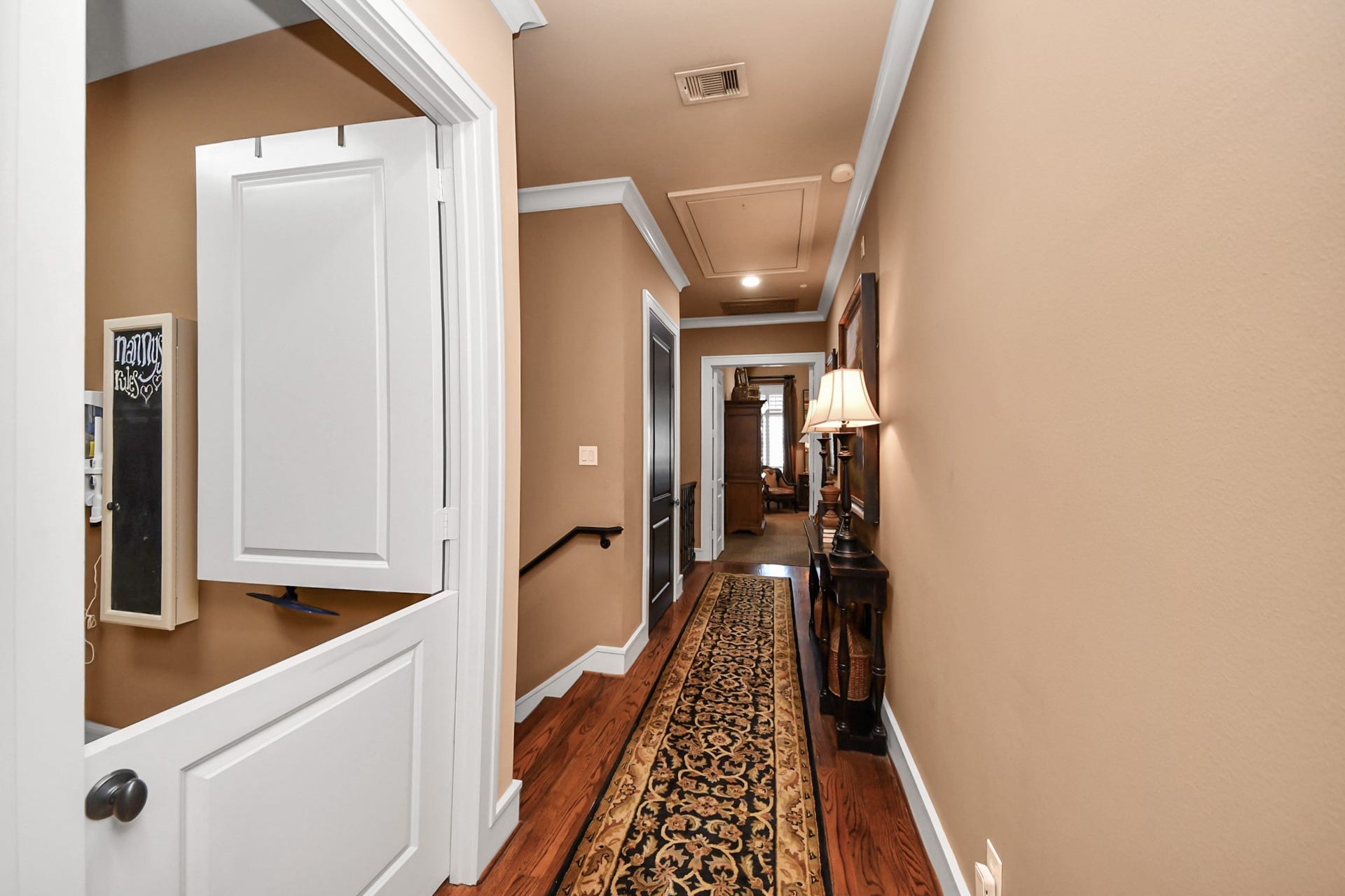 1406 Lake Pointe Parkway, Sugar Land, TX 77478 Gallery-style hall leads from 3rd floor guest to the secluded primary suite on the other side of the home. The thoughtful layout enhances privacy while maintaining a seamless flow between functional and retreat spaces.