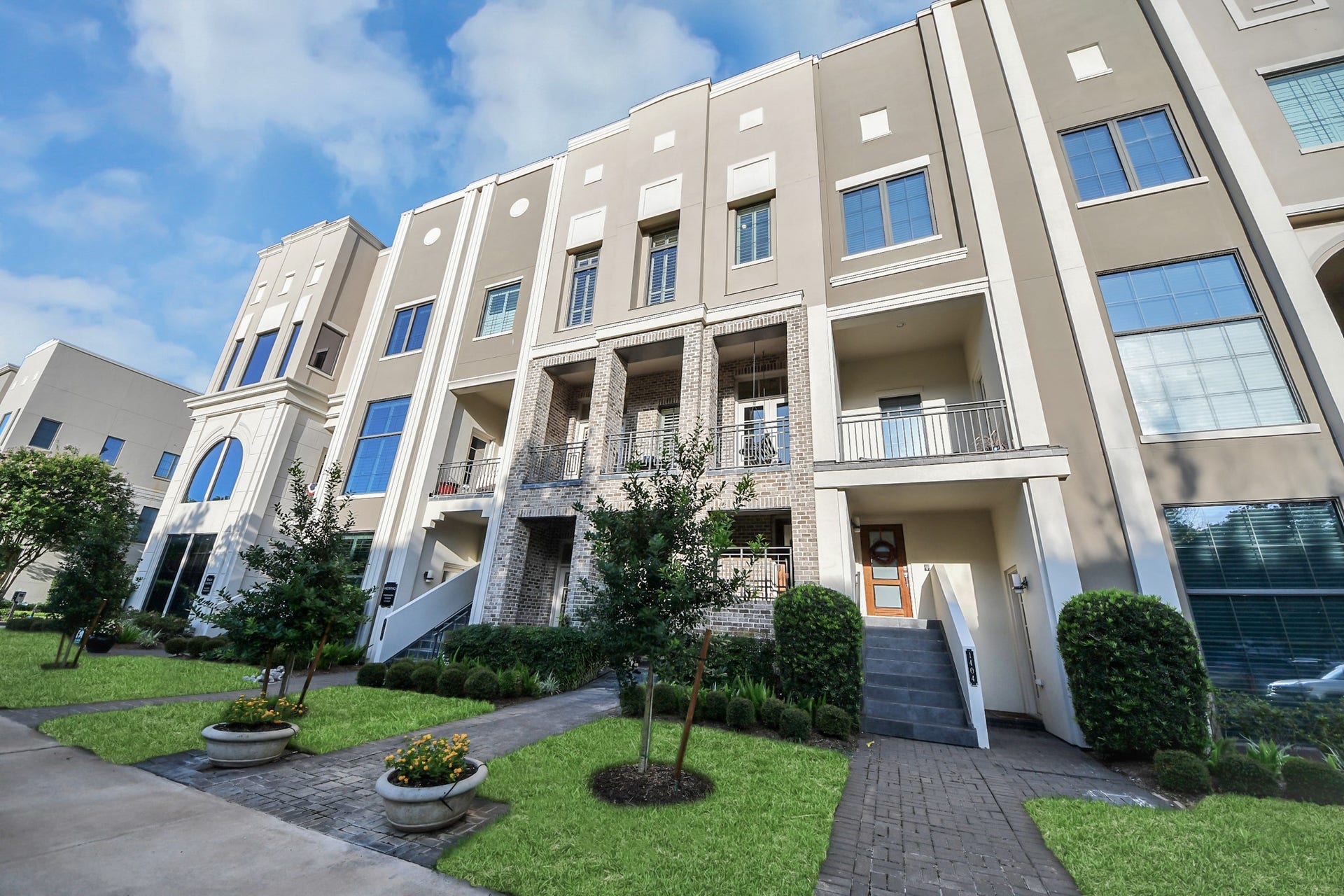 1406 Lake Pointe Parkway, Sugar Land, TX 77478 A striking brick and stucco townhouse with elevator, this highly desirable live/work residence fronting Lake Pointe Parkway is ideal for both office and residential use, with guest parking just steps from the entry.