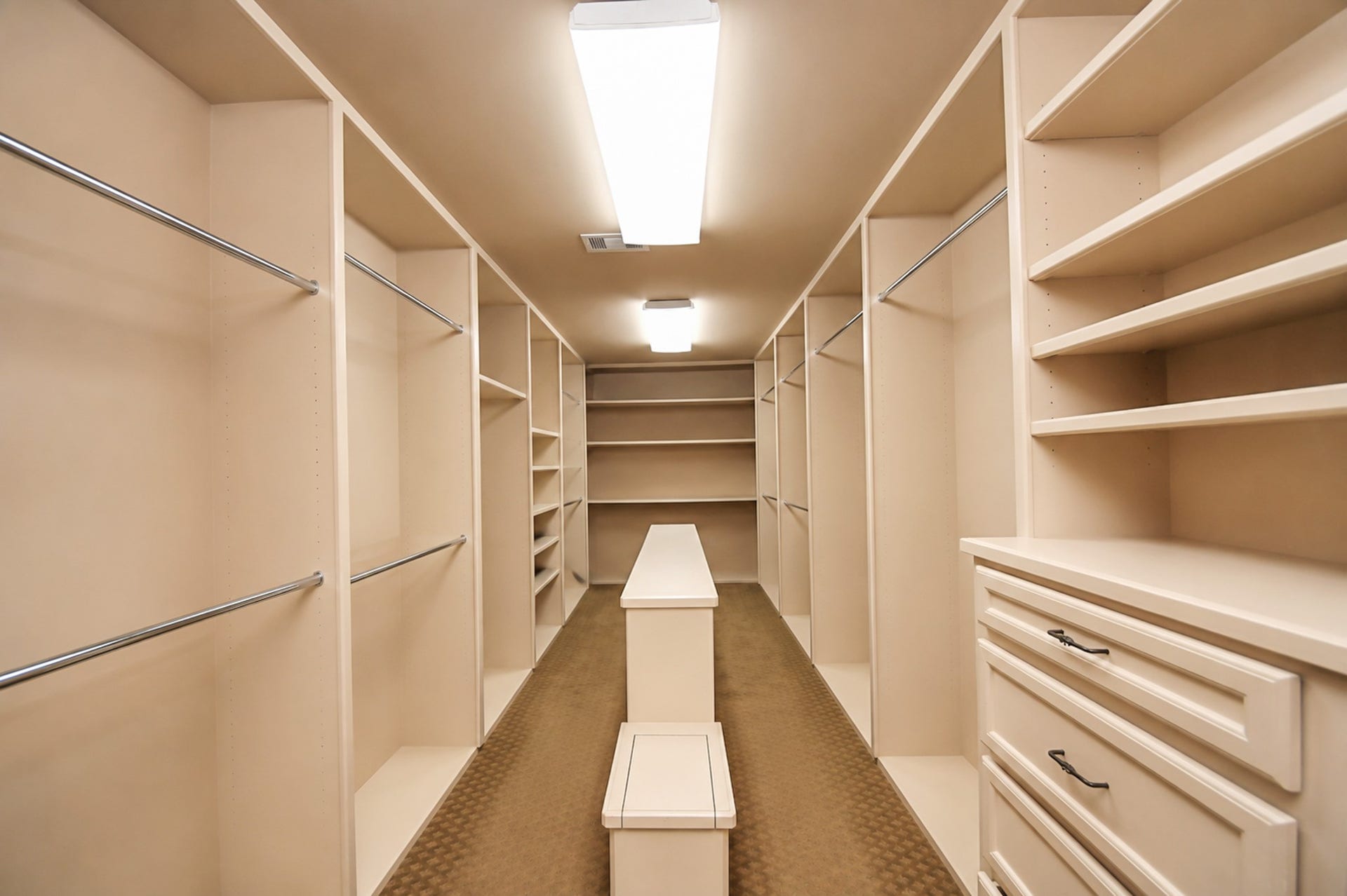 1406 Lake Pointe Parkway, Sugar Land, TX 77478 Exceptional closet with custom storage solutions and a thoughtfully placed, dedicated work space for catching up with emails ahead of the work day.