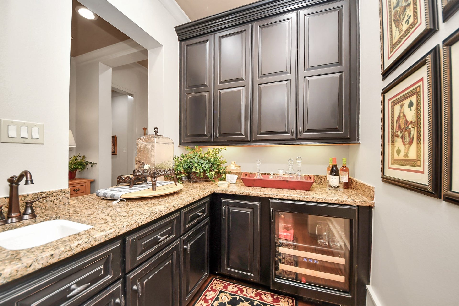 1406 Lake Pointe Parkway, Sugar Land, TX 77478 Well-appointed wet bar with beverage fridge, seamlessly integrated into the main entertaining space.