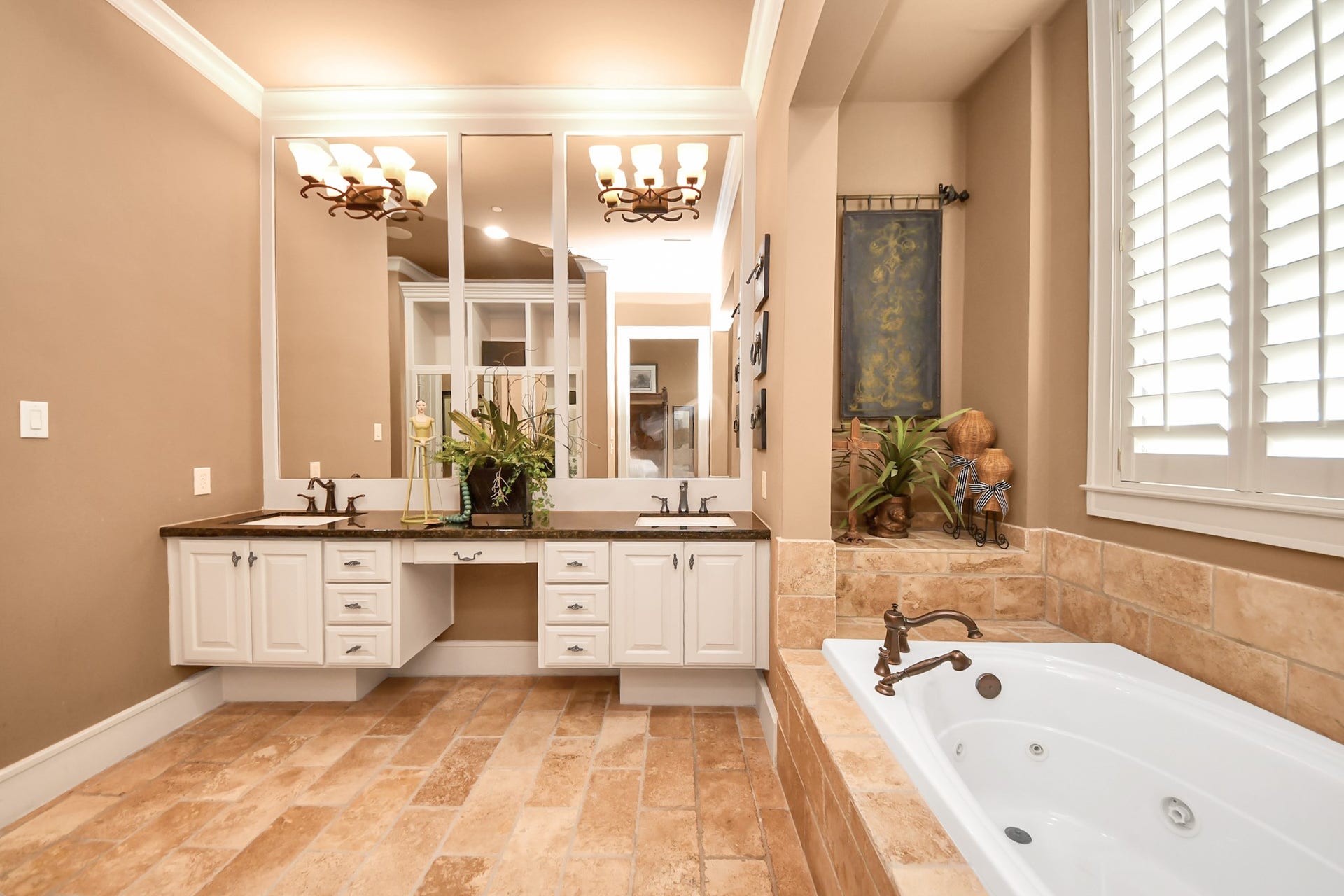 1406 Lake Pointe Parkway, Sugar Land, TX 77478 Expansive vanity and jetted soaking tub bathed in natural light from a nearby window.