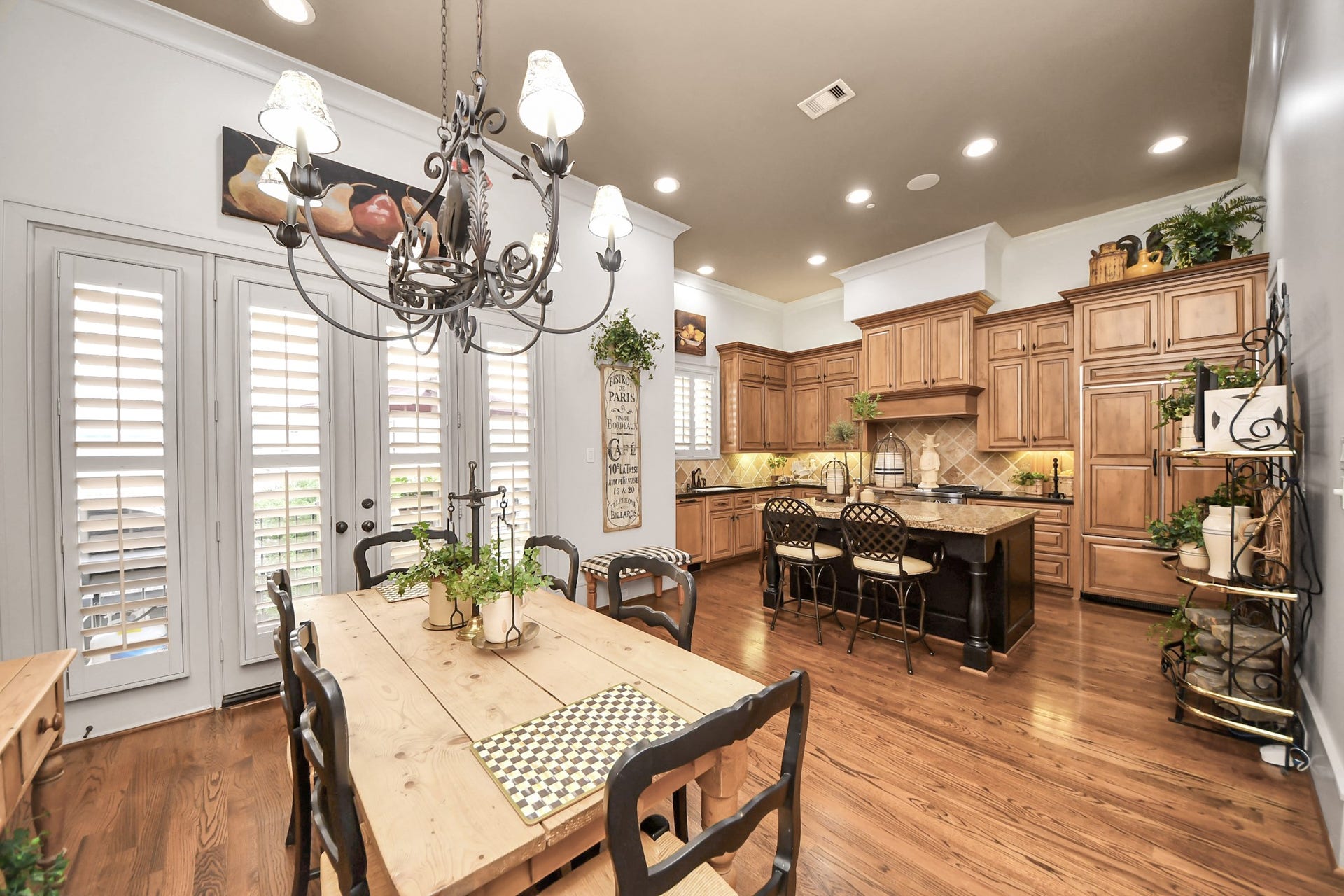 1406 Lake Pointe Parkway, Sugar Land, TX 77478 Bright kitchen and breakfast area with oversized island, custom cabinetry, walk-in pantry and seamless access to the patio, which is perfect for grilling.
