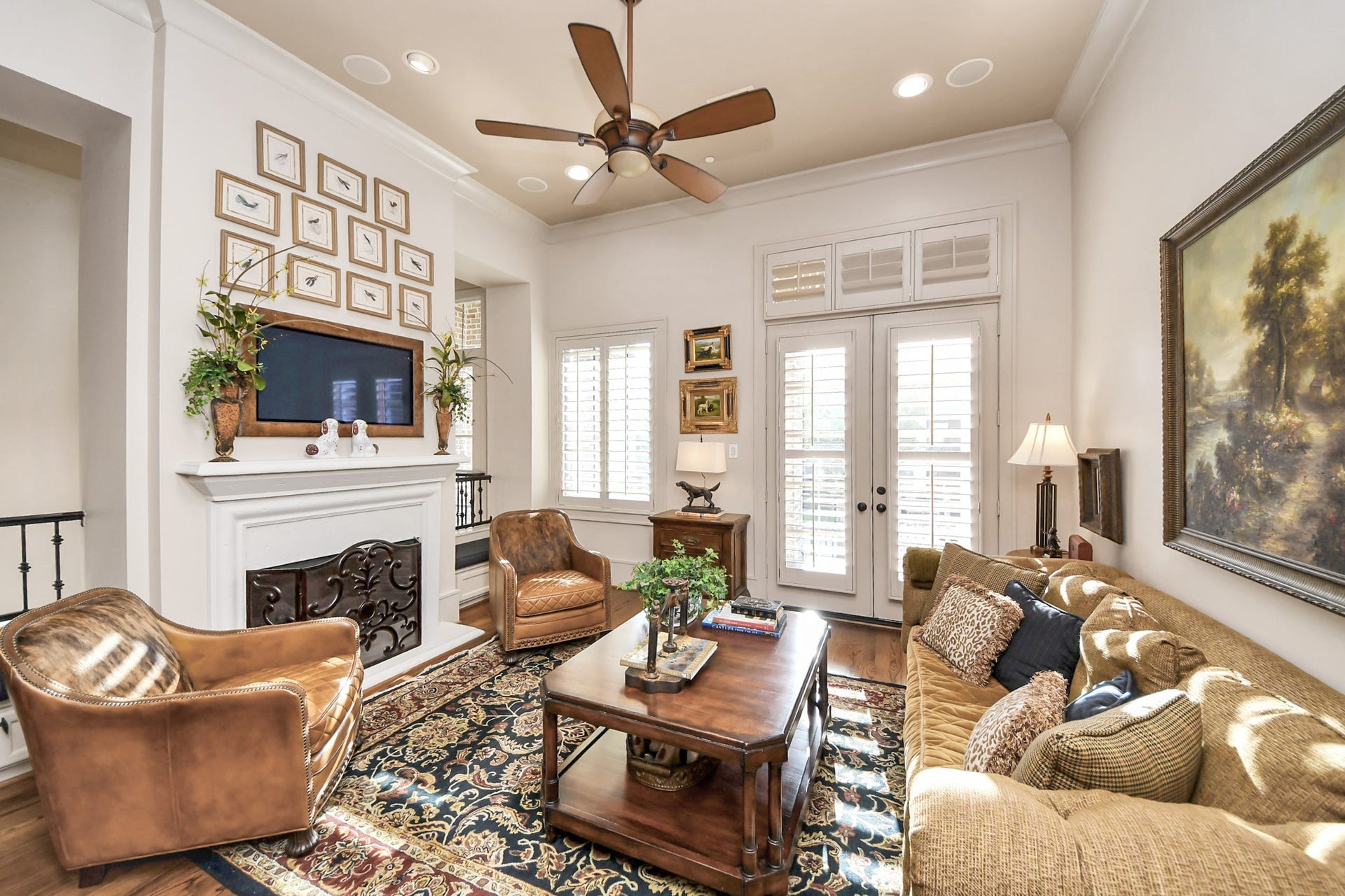1406 Lake Pointe Parkway, Sugar Land, TX 77478 Spacious living room with soaring ceilings, refined millwork, fireplace, and those rich, beautiful hardwoods.