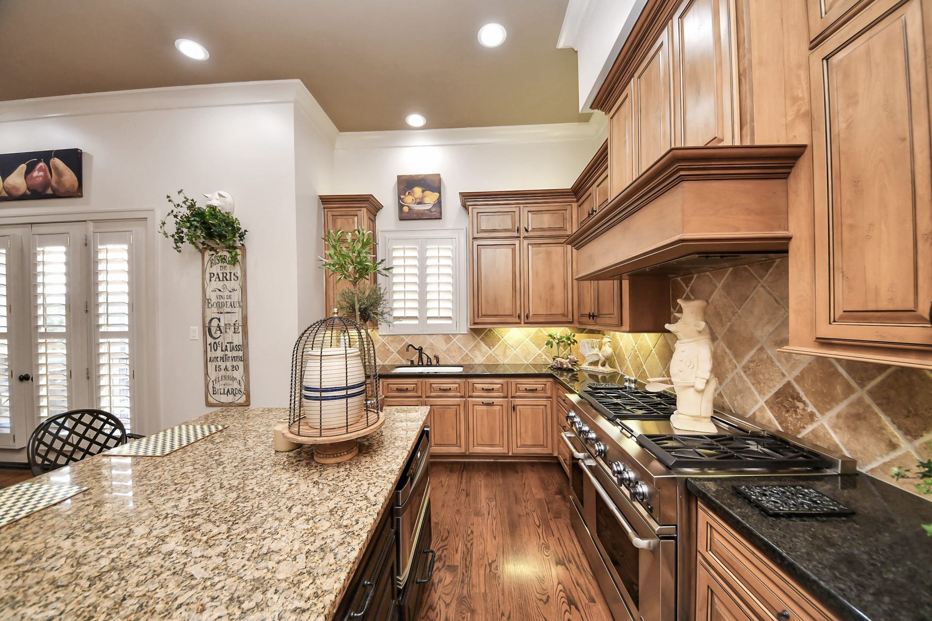 1406 Lake Pointe Parkway, Sugar Land, TX 77478 Well-lit workspaces enhance both function and design within the beautifully appointed kitchen.
