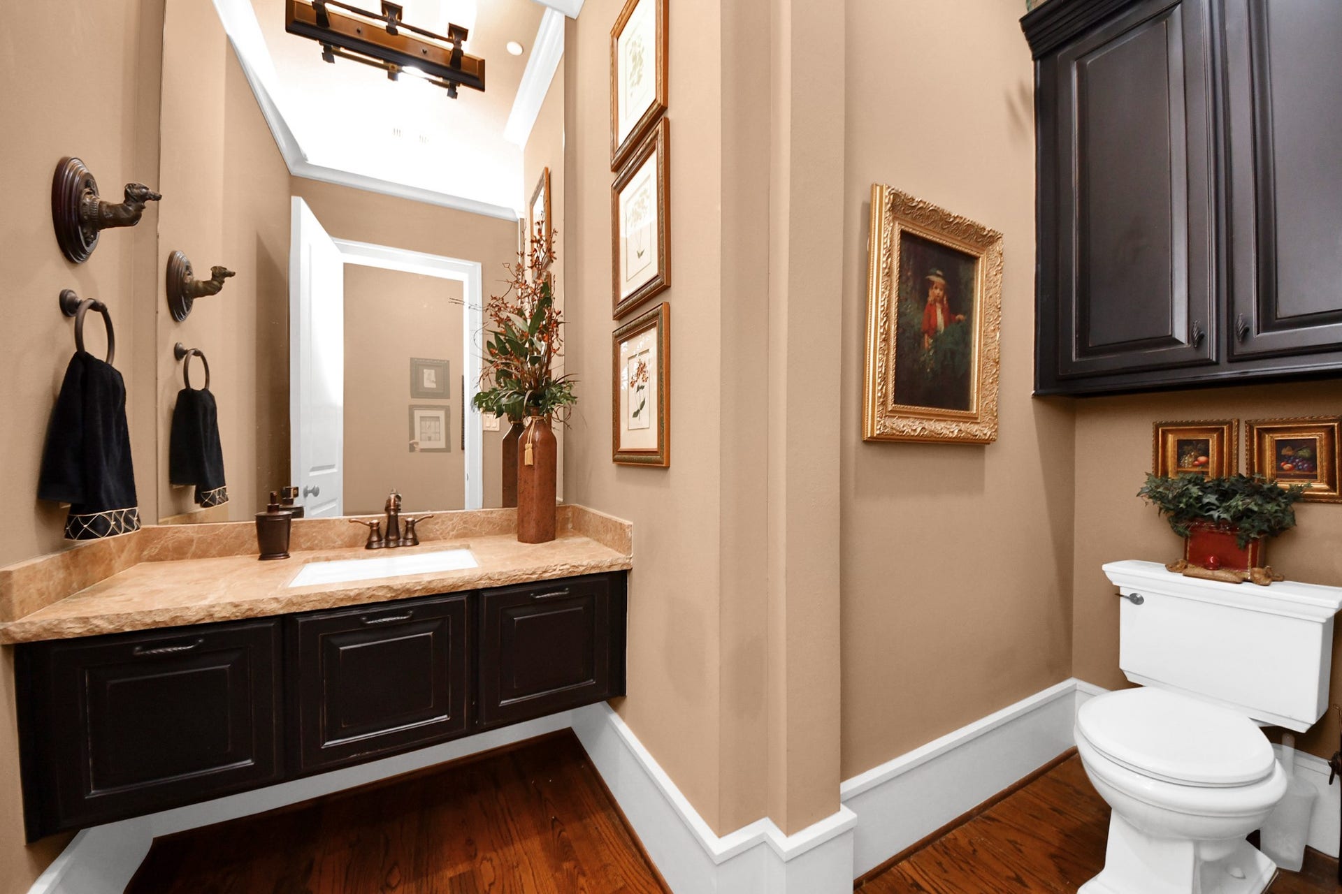 1406 Lake Pointe Parkway, Sugar Land, TX 77478 Pretty powder room featuring a floating vanity with stone countertop and polished finishes. Note the crisp 8" baseboards throughout.