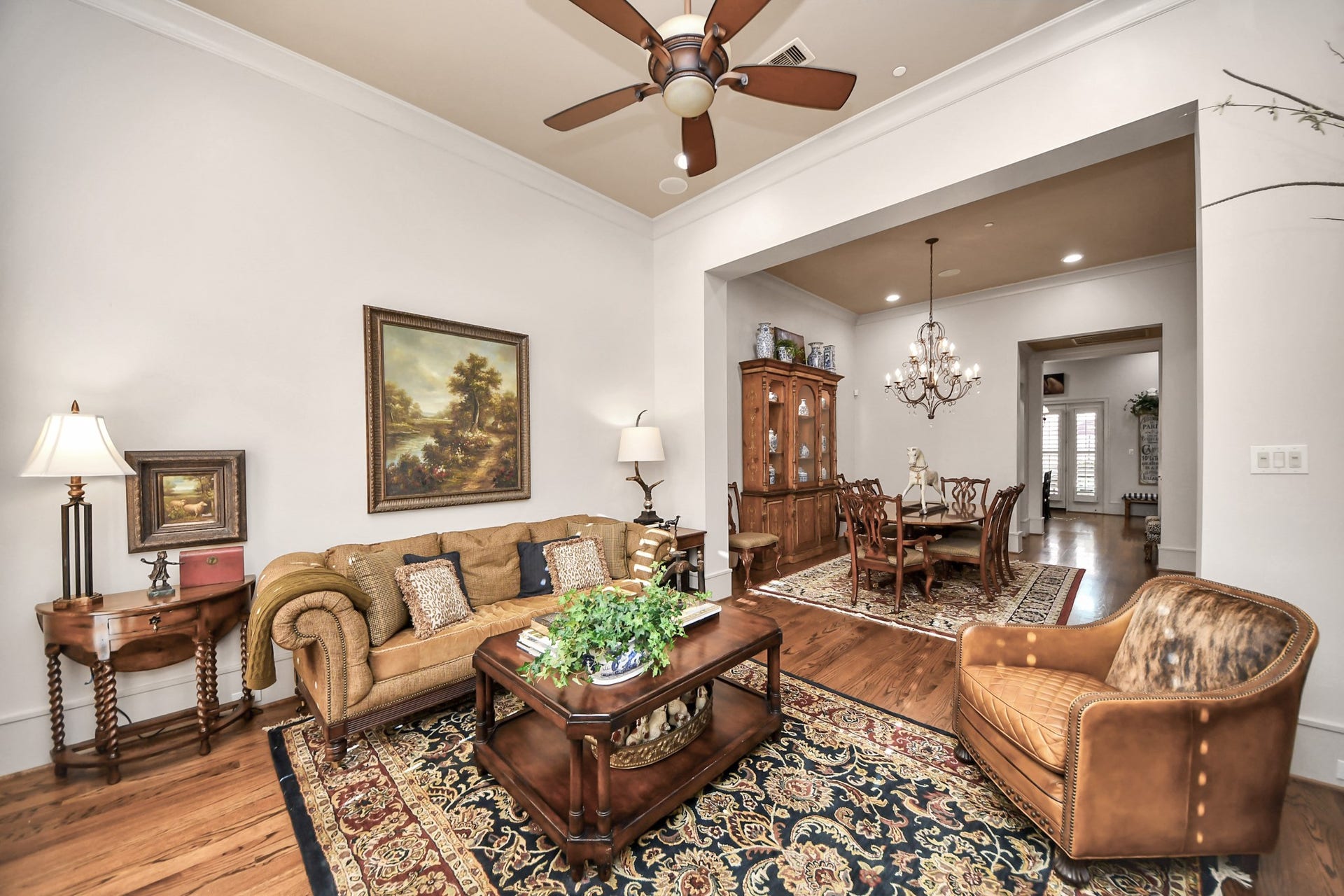 1406 Lake Pointe Parkway, Sugar Land, TX 77478 Main living area seamlessly connects to the formal dining, highlighted by plantation shutters, recessed lighting, and gleaming hardwood floors.