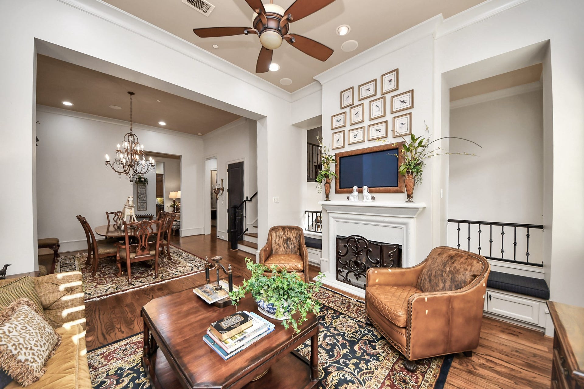 1406 Lake Pointe Parkway, Sugar Land, TX 77478 This cozy gathering space centers around the fireplace with balconies overlooking the foyer. Walk-out patio overlooking the front parkway, offering seamless indoor-outdoor flow for entertaining.