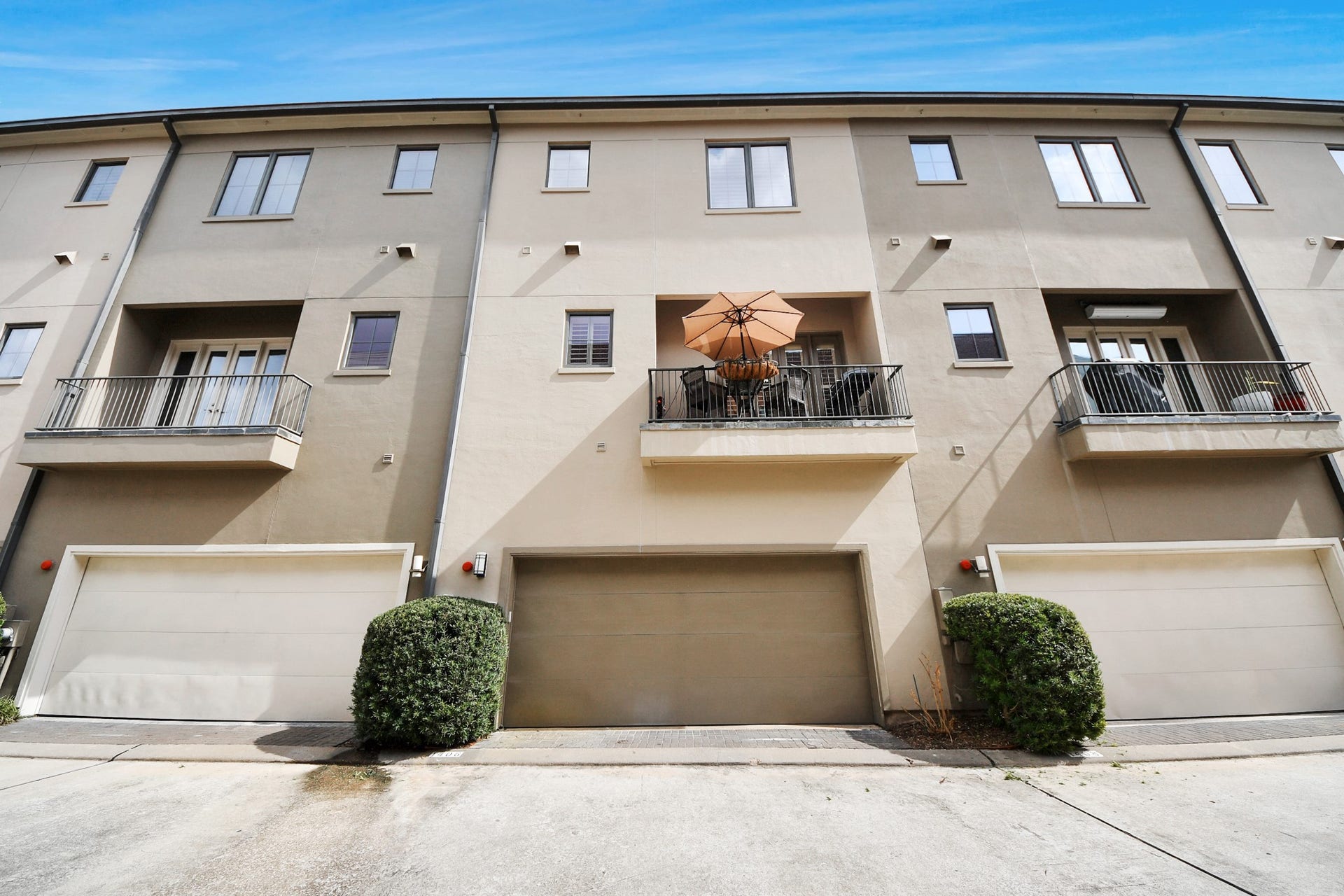 1406 Lake Pointe Parkway, Sugar Land, TX 77478 Private rear-entry garages accessed through a secured gated drive, offering both convenience and peace of mind. Wide interior streets provide generous maneuverability.