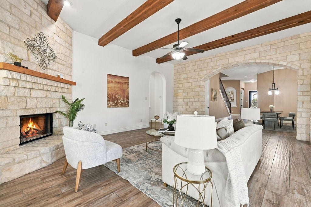 2936 Hawkins Creek Lane, League City, TX 77573 Relax by the floor-to-ceiling stone fireplace that centers the main living area.