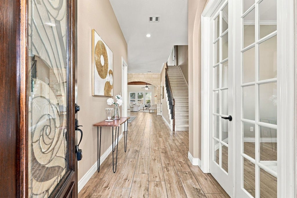 2936 Hawkins Creek Lane, League City, TX 77573 Step into a bright and open entryway with beautiful wood floors.