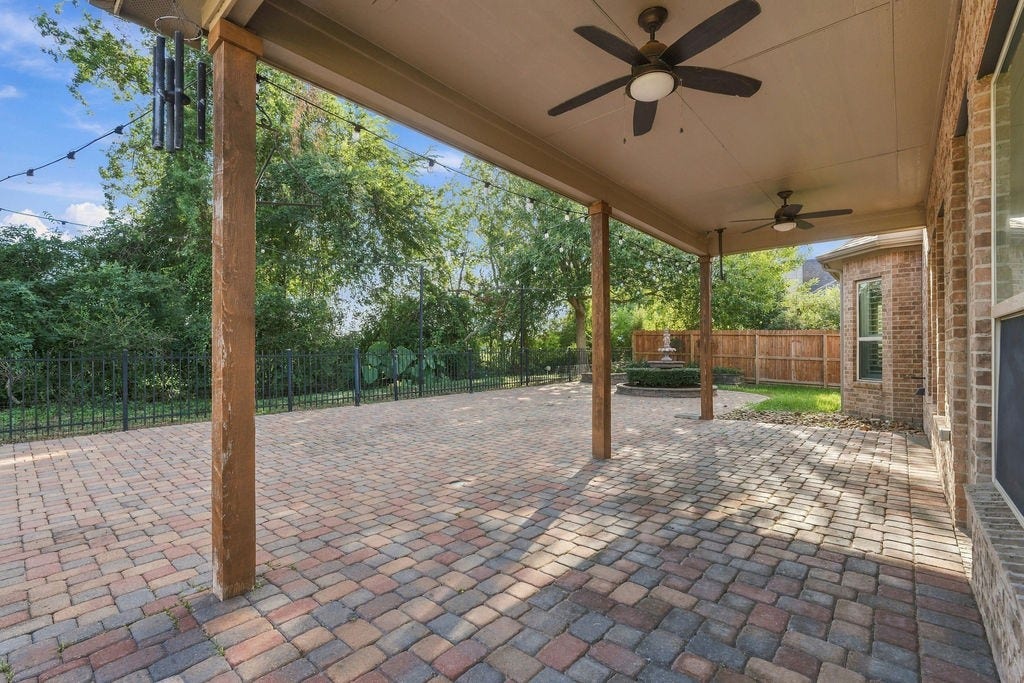 2936 Hawkins Creek Lane, League City, TX 77573 Step out to the covered back porch, complete with ceiling fans to keep you cool on warm days.