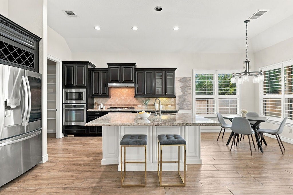2936 Hawkins Creek Lane, League City, TX 77573 The massive island kitchen features plenty of workspace and is the true heart of this home.