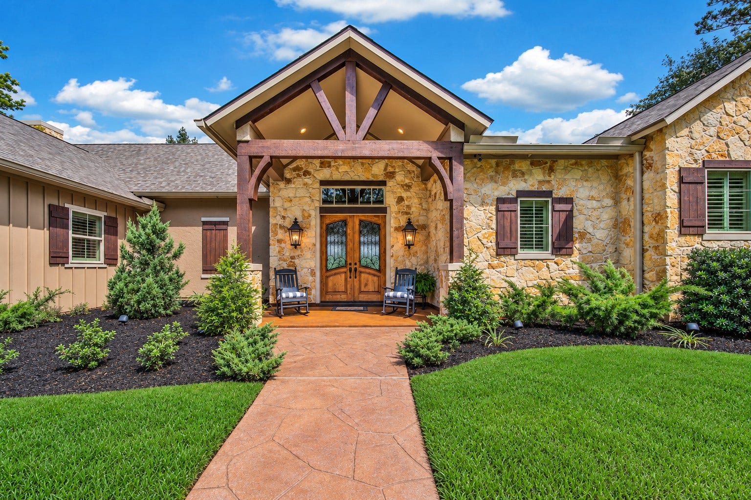 A timber-framed porch and warm stonework set the tone before the door opens. This entrance offers the first glimpse of the craftsmanship carried throughout the home.